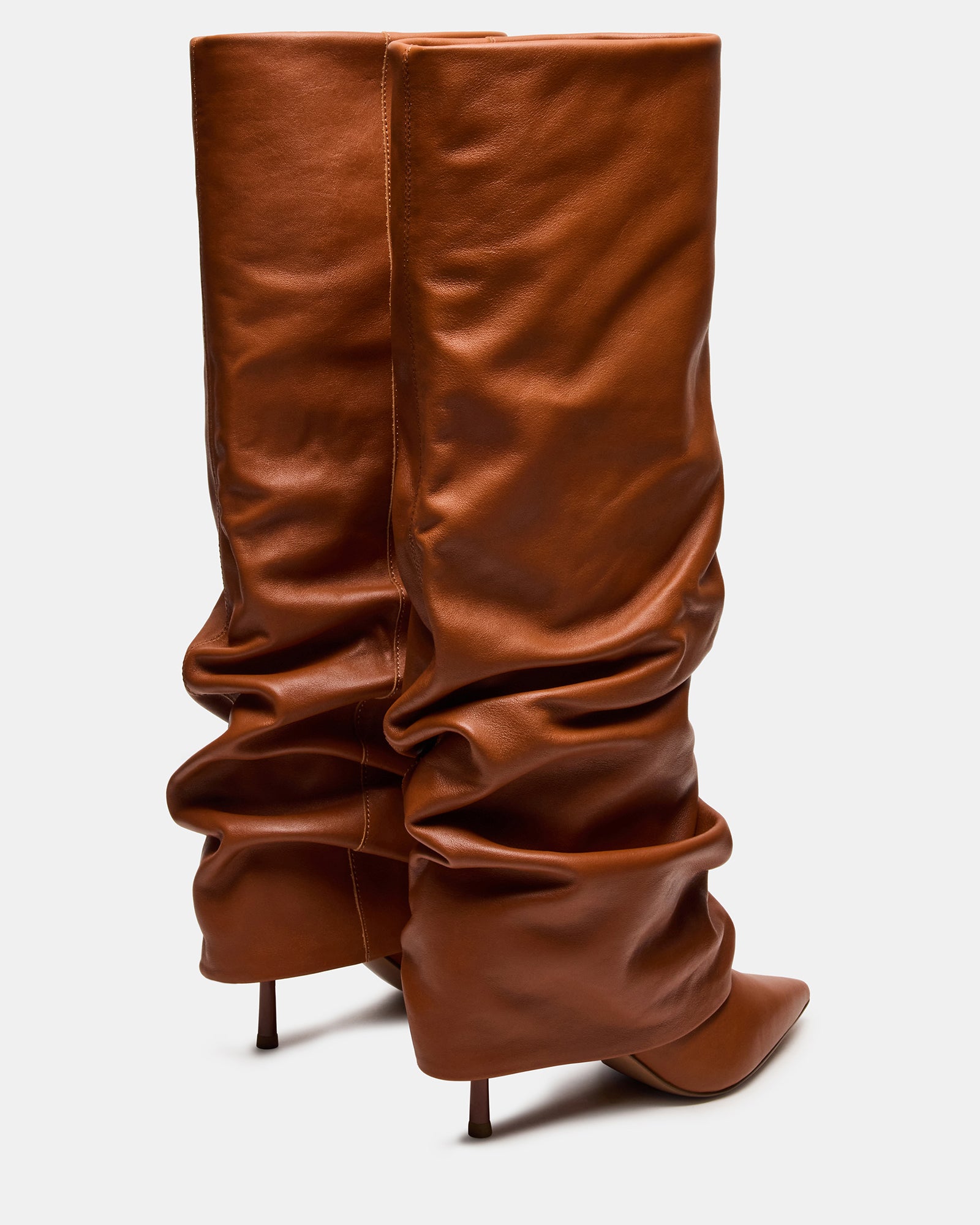 Close-up of the pointed toe design and leather texture of tan leather boots