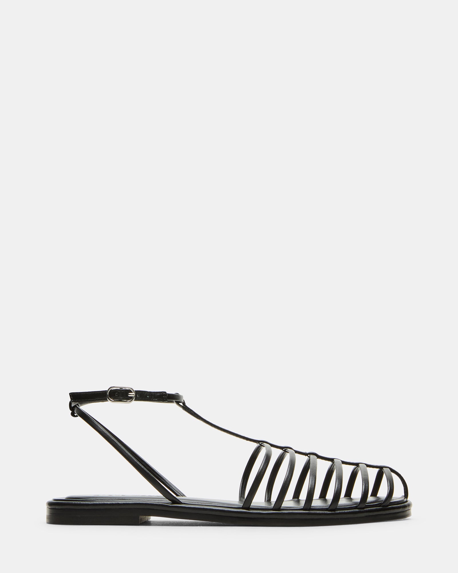 Side view of Marin Black women's fisherman sandals on a sandy beach.