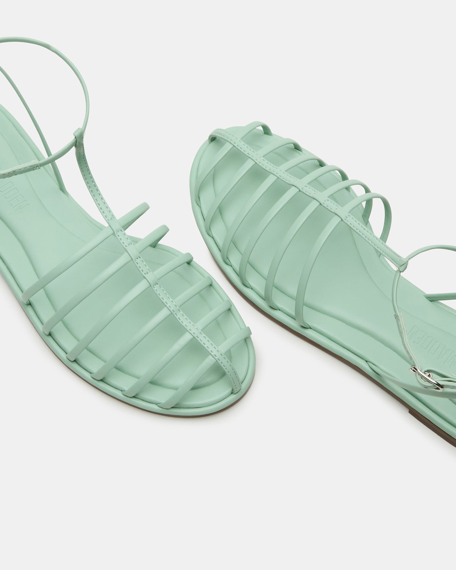 Marin Pistachio sandals worn casually on a summer day.