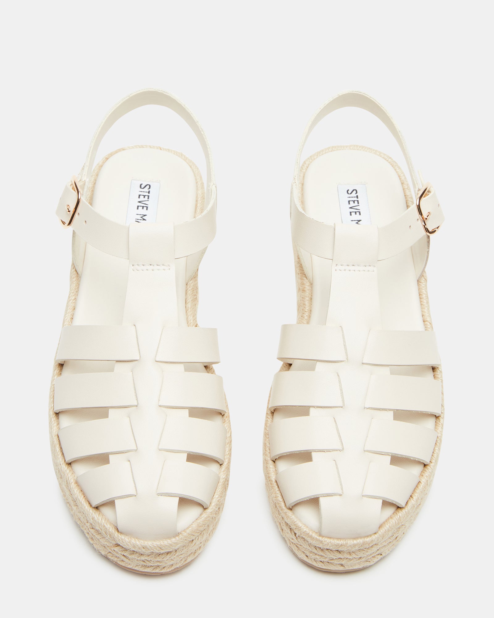 Front angle of black leather sandals with fisherman straps on wood deck