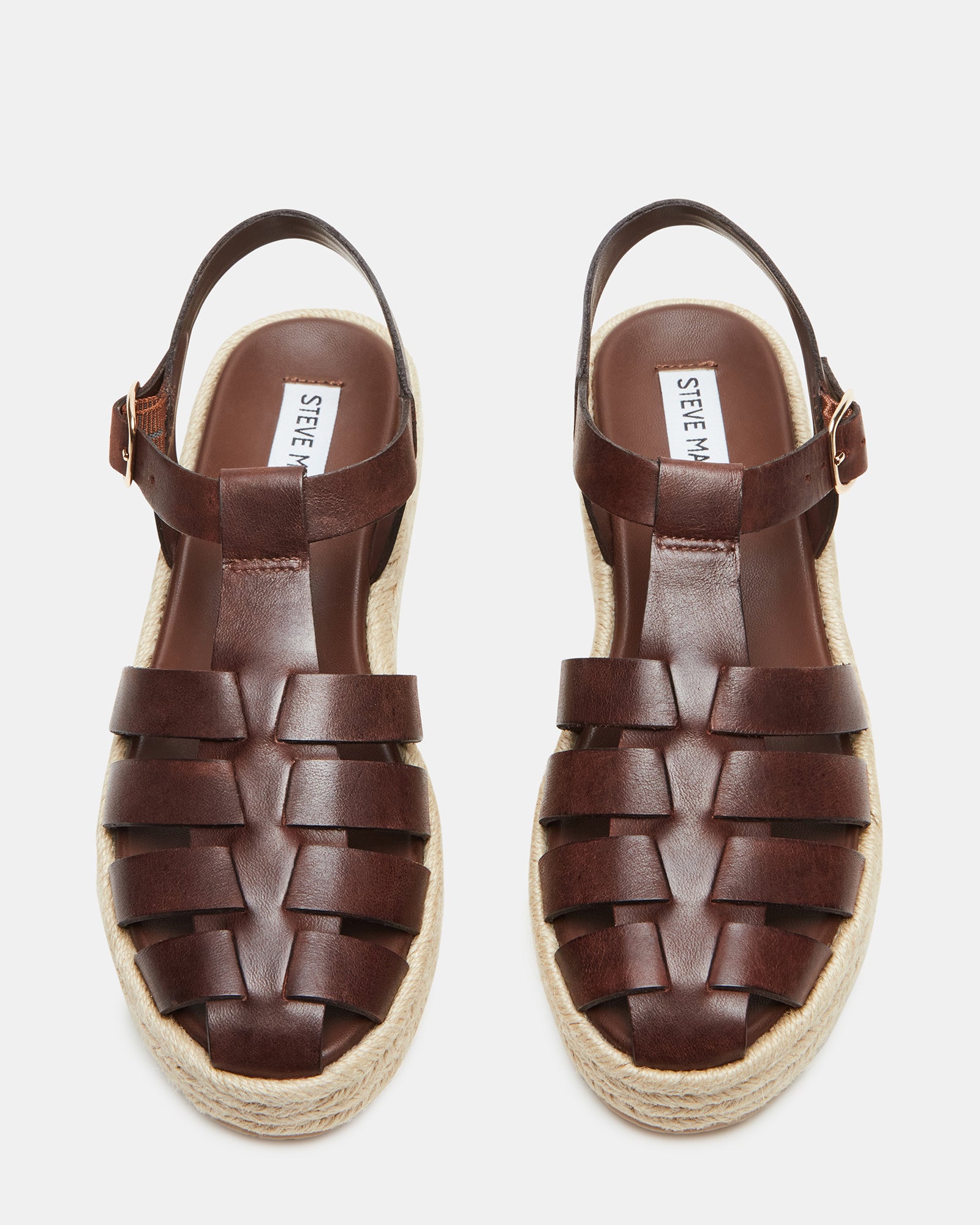 Brown leather espadrille sandals showcasing a strappy design from the side.