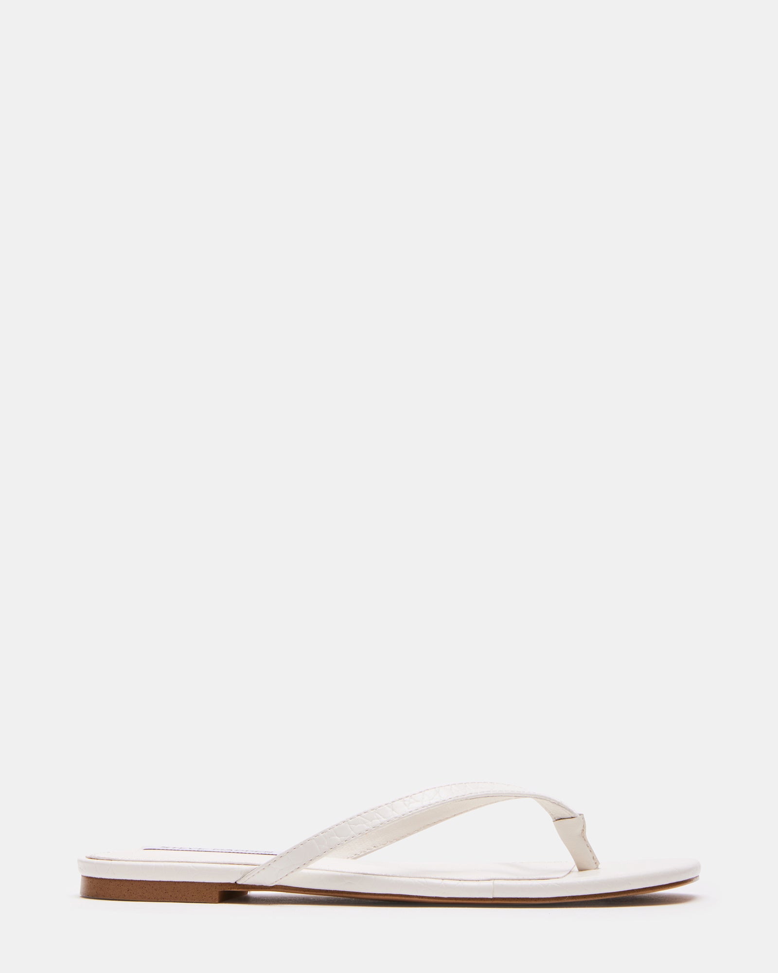 Elegant Marnie Bone Thong Sandals with Heels on a sunny day