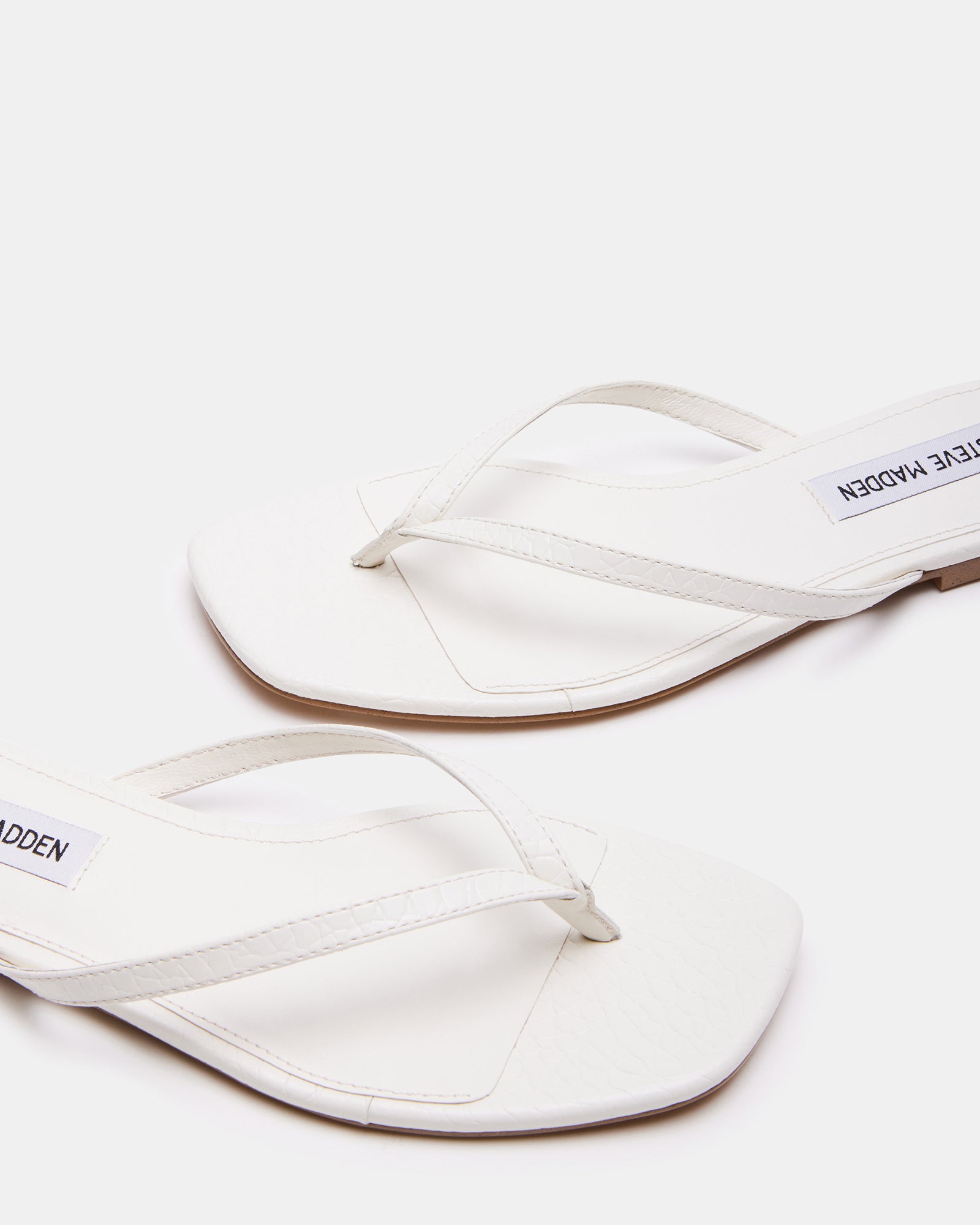 Elegant Marnie Bone Thong Sandals with Heels on a sunny day