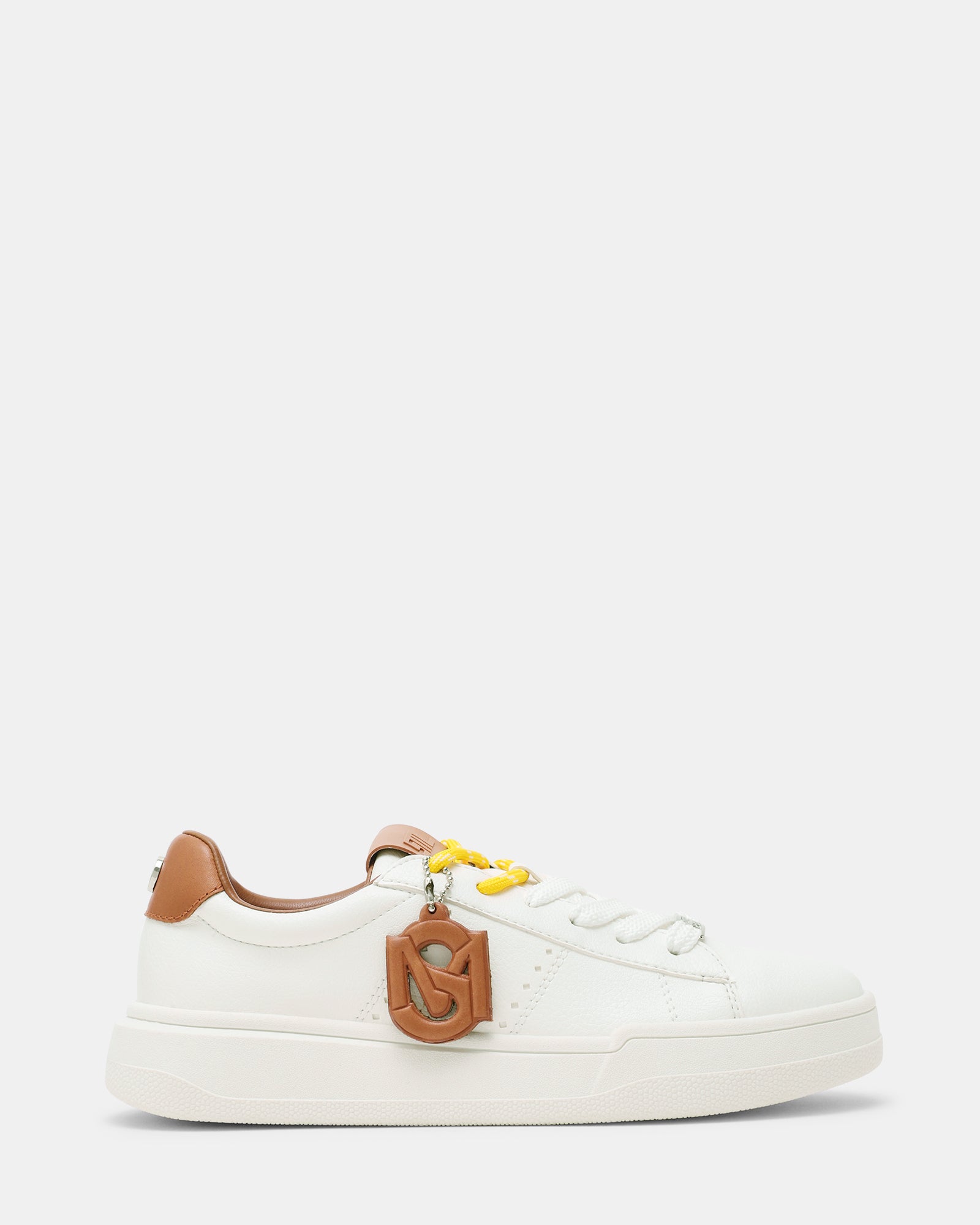 Side profile of white and tan lace up sneakers with decorative charm—ideal for city walks.