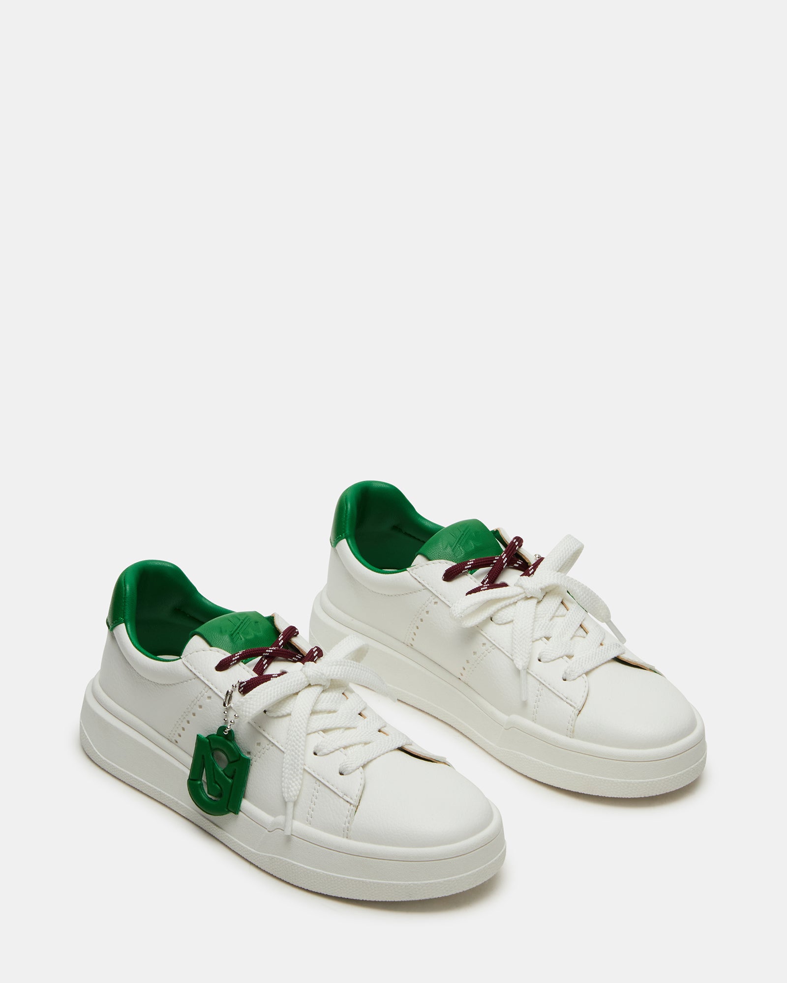 Side profile of stylish sneakers showing the synthetic sole and design