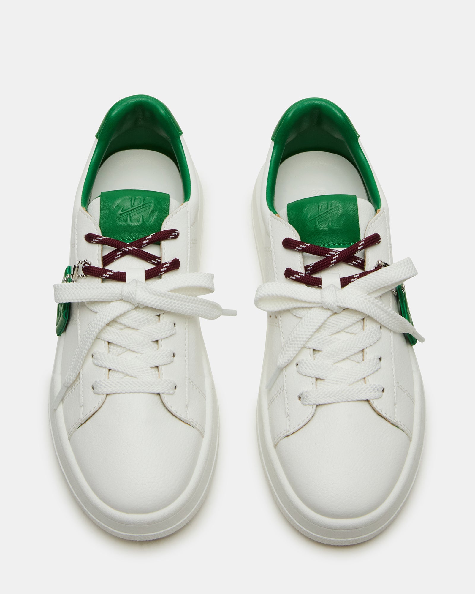 Front view of Marvin white and green low-top sneakers with shoe charm detail