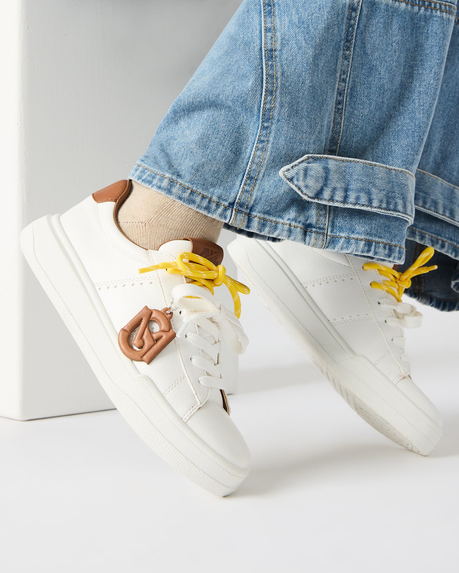 Top view showing laces and padded interior of womens black sneakers on concrete surface.