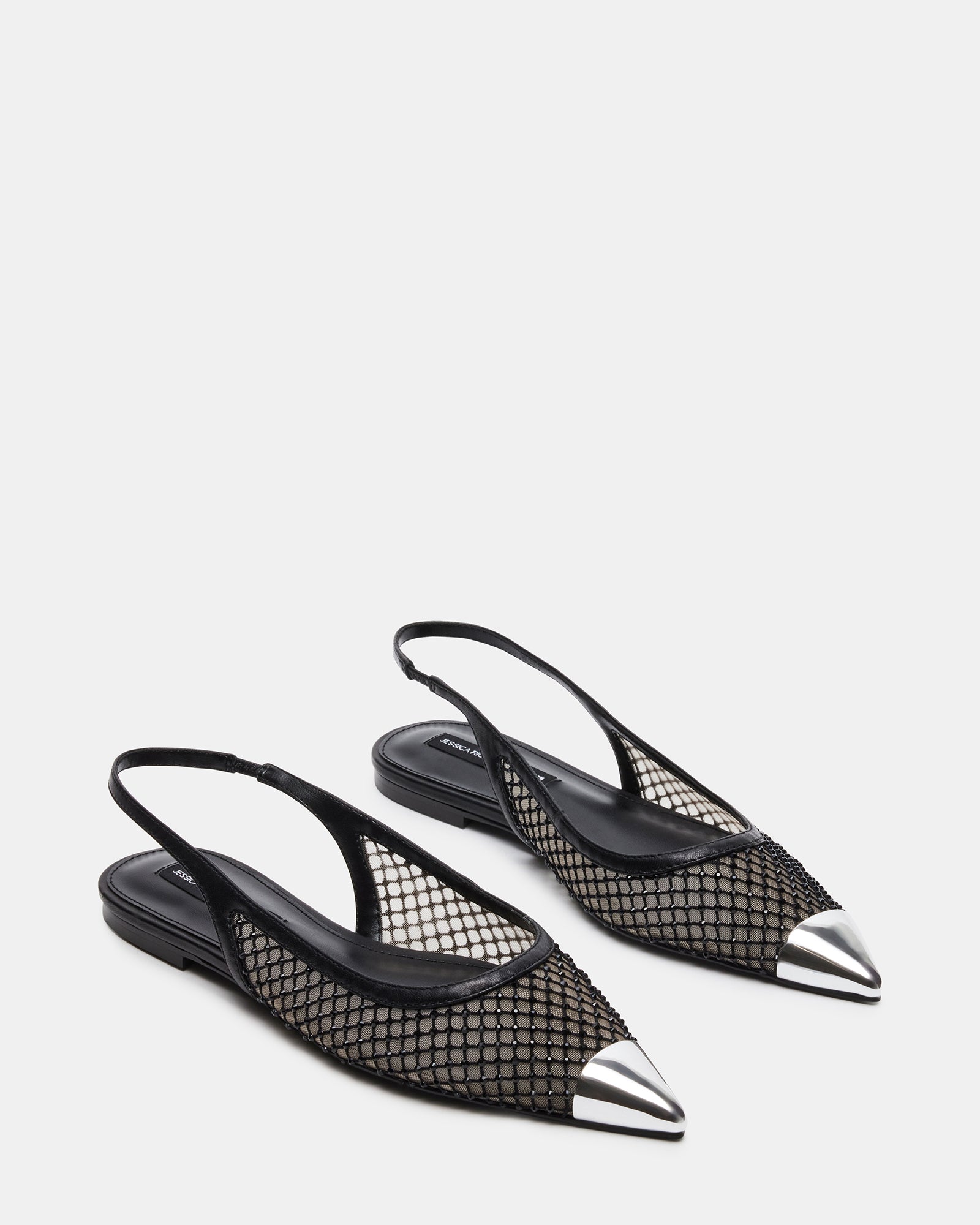 Side profile of black slingback flats highlighting silver cap and arch shape