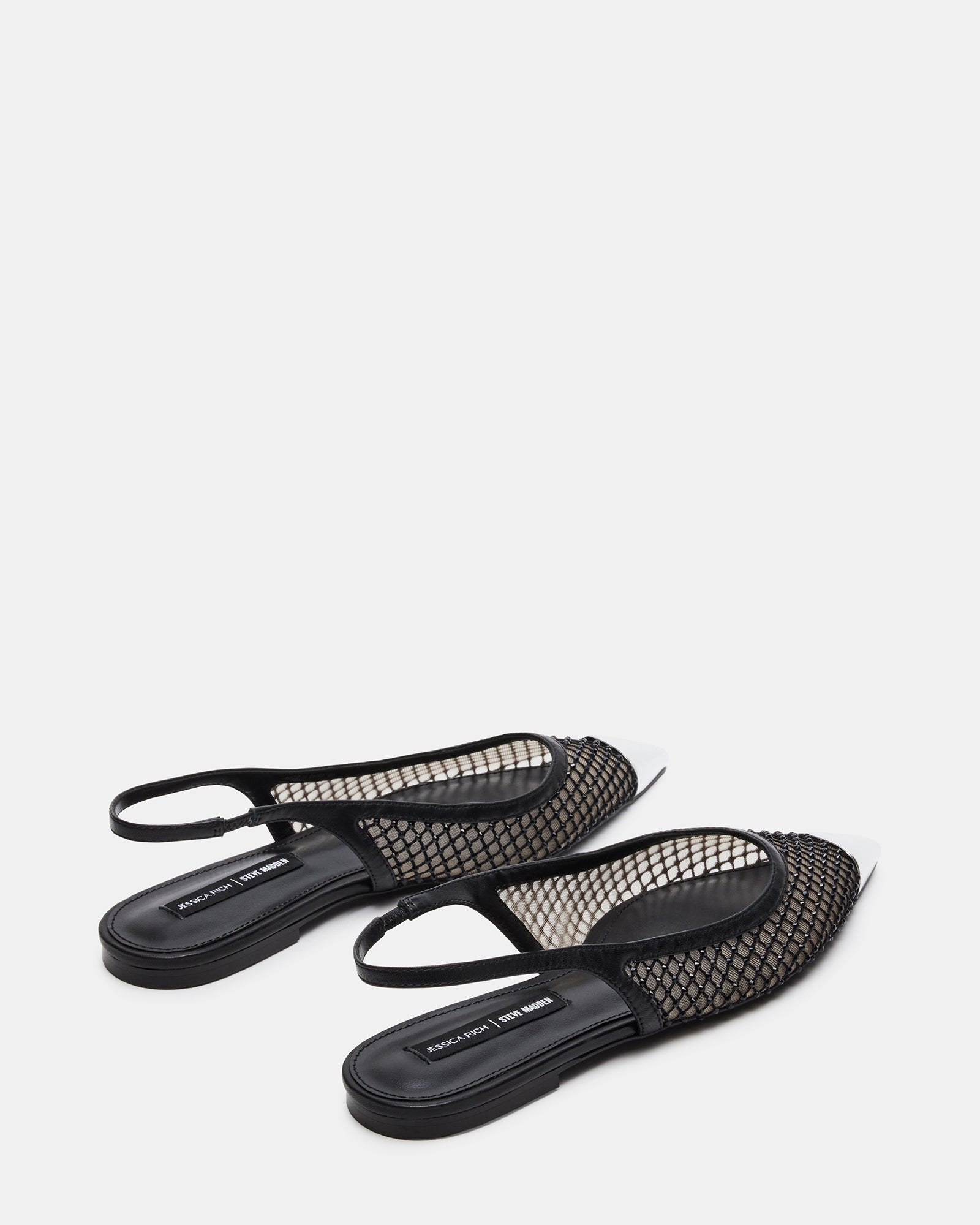 Side profile of black slingback flats highlighting silver cap and arch shape