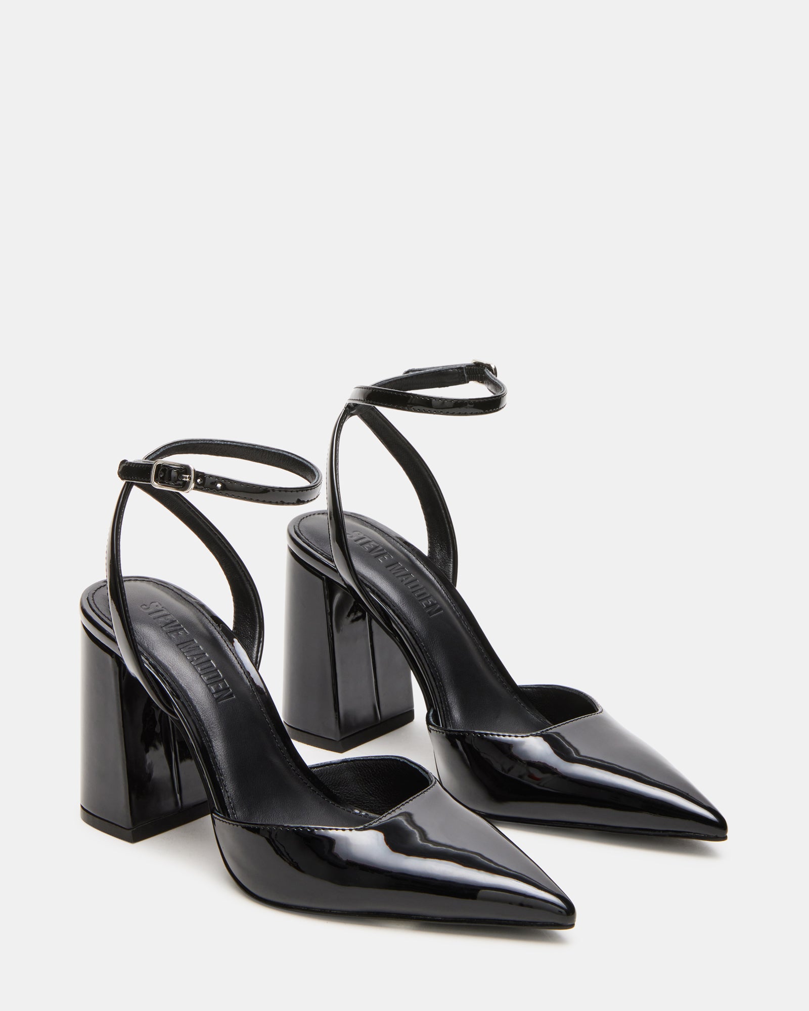 Close-up of the crisscross strap detail on MATTEA black patent heels.