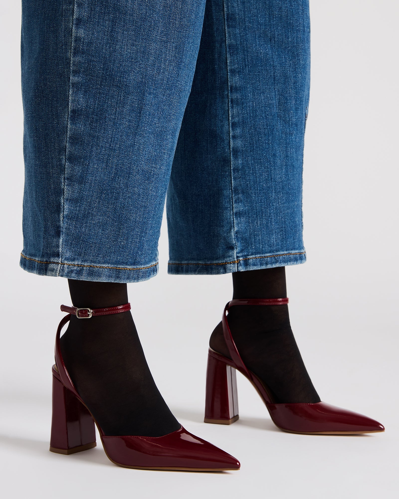 Close-up of the gold-accented block heel and pointed toe.