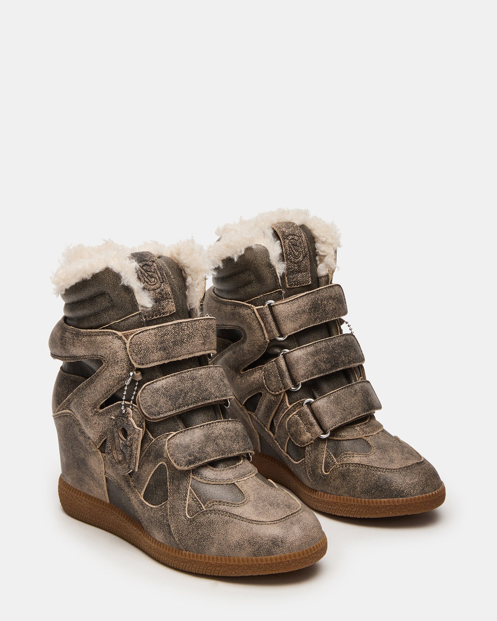 Close-up of the Velcro closure and textured sole on the faux fur sneakers