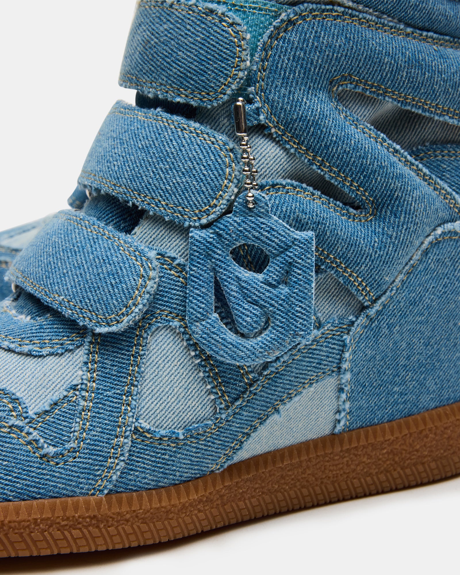 Close-up of the synthetic sole and hidden wedge on women’s high top sneakers for added height and comfort
