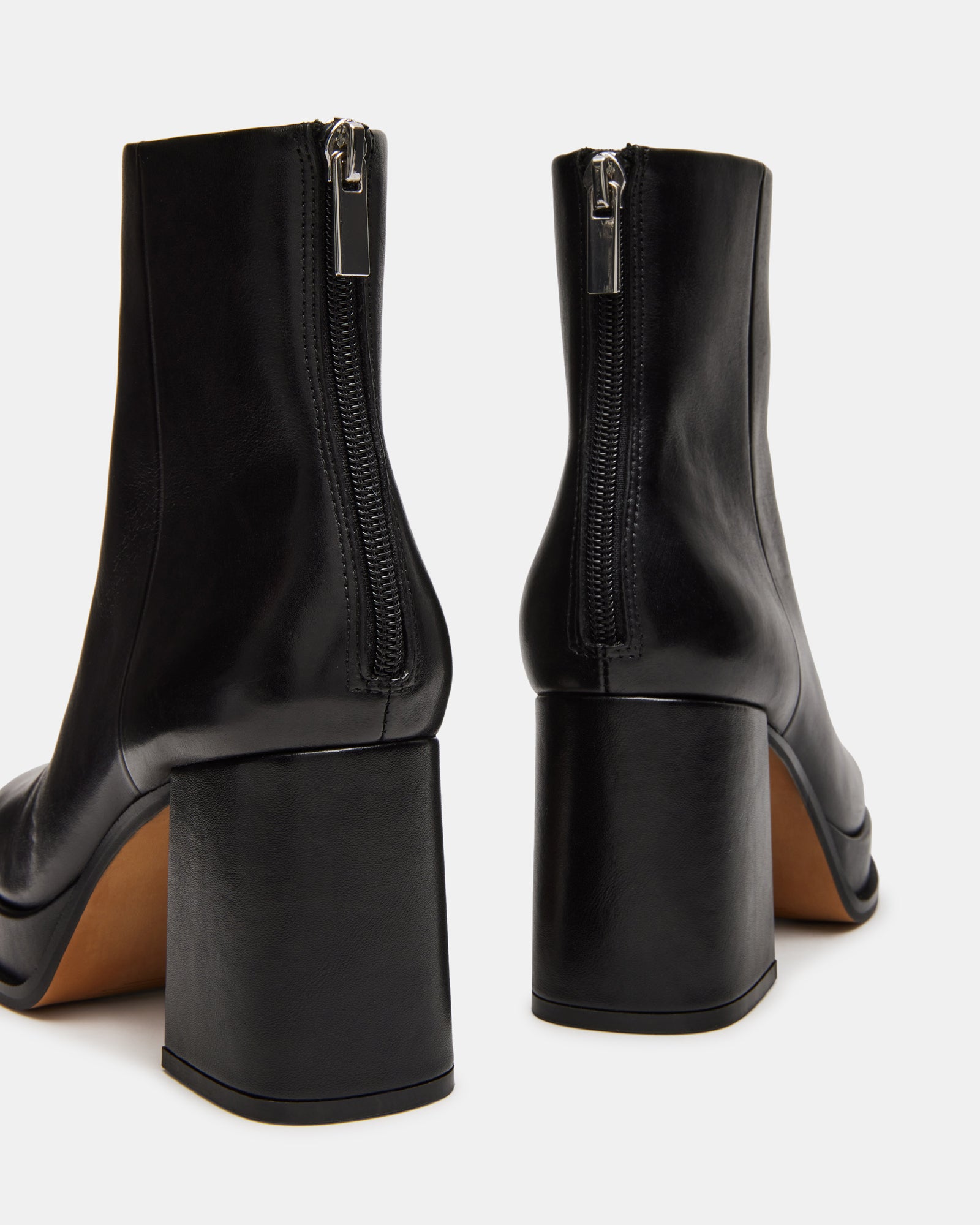 Side view of black ankle boots ankle boots showing square toe and bold block heel