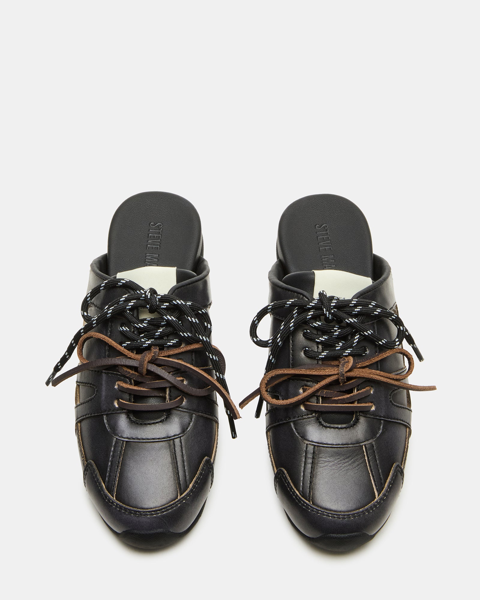 Top-down angle of slip-on shoes showing textile lining and secure lace-up detail
