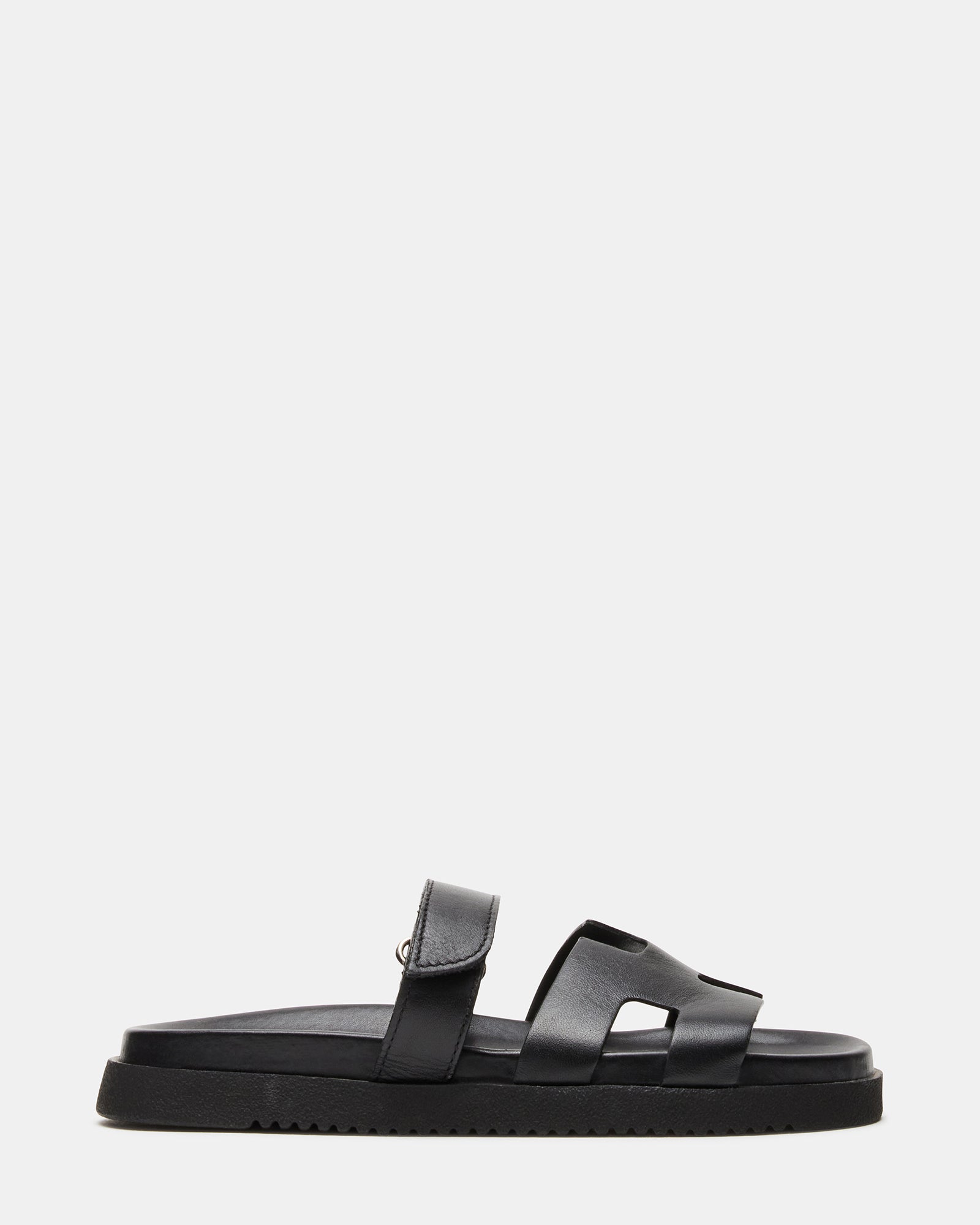 Side view of MAYVEN black leather flatform slides showcasing adjustable strap.