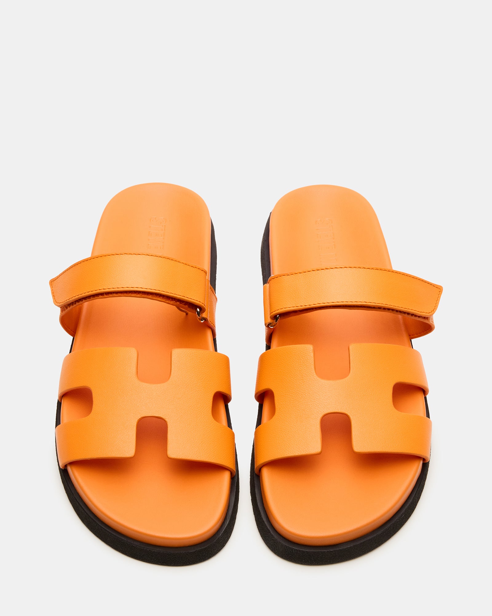 Top view of leather slide sandals showcasing adjustable strap and molded footbed