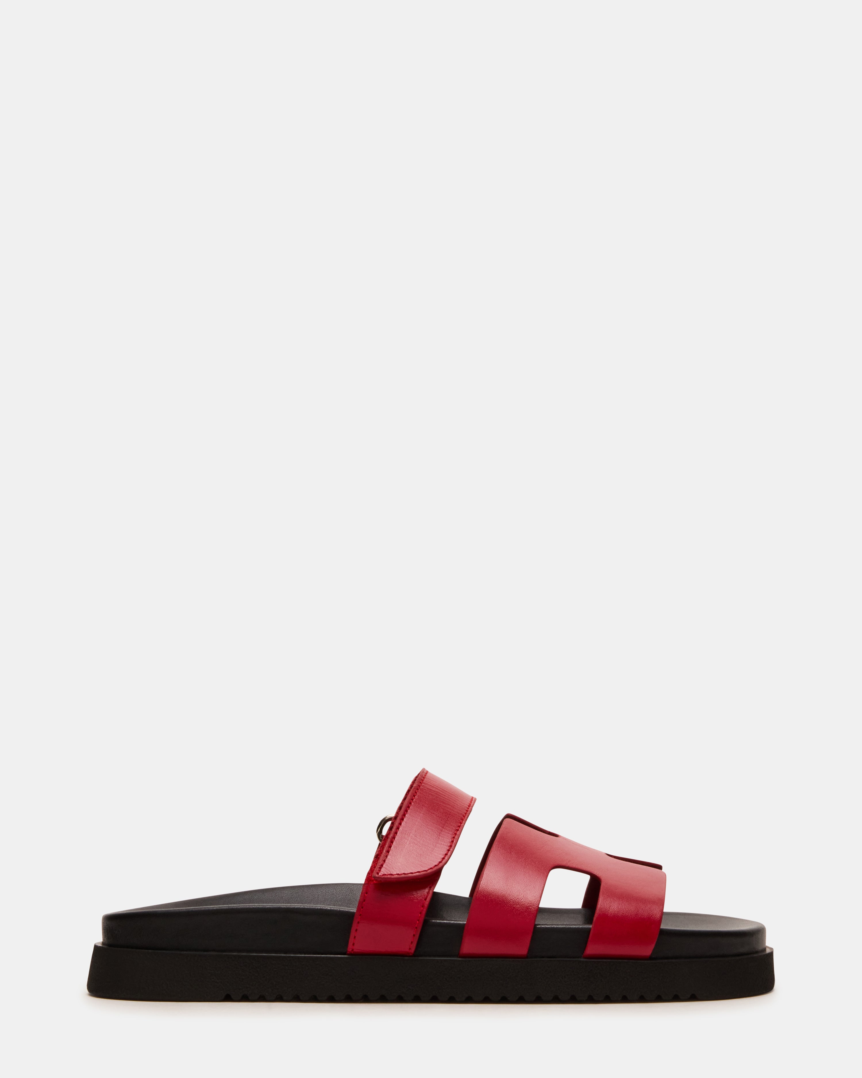 Side view of MAYVEN red leather flatform slides highlighting the geometric cutout design.