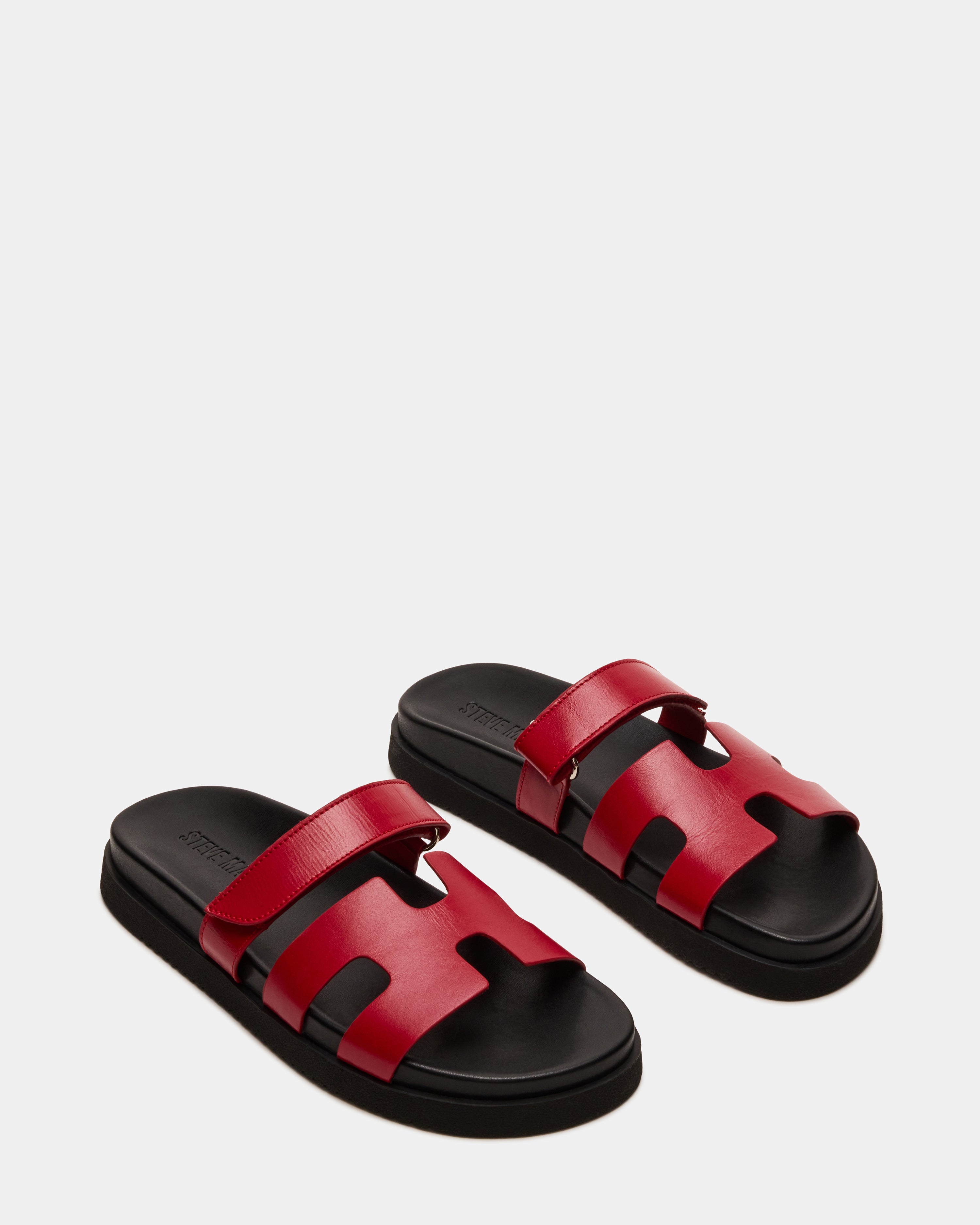 Lifestyle shot of MAYVEN flatform sandals worn casually in a sunny park setting.