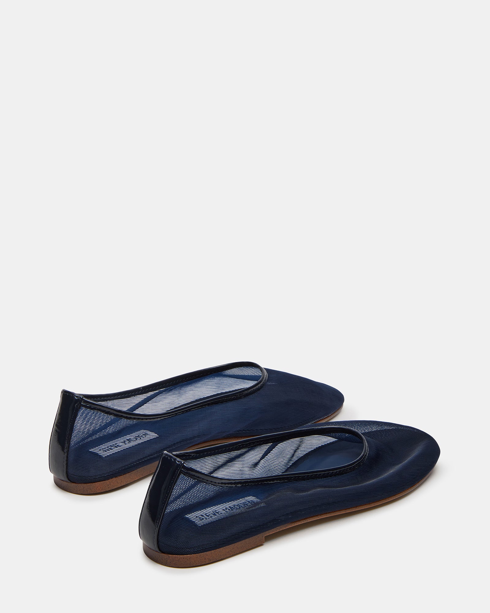 Model wearing navy mesh ballet flats paired with casual outfit outdoors