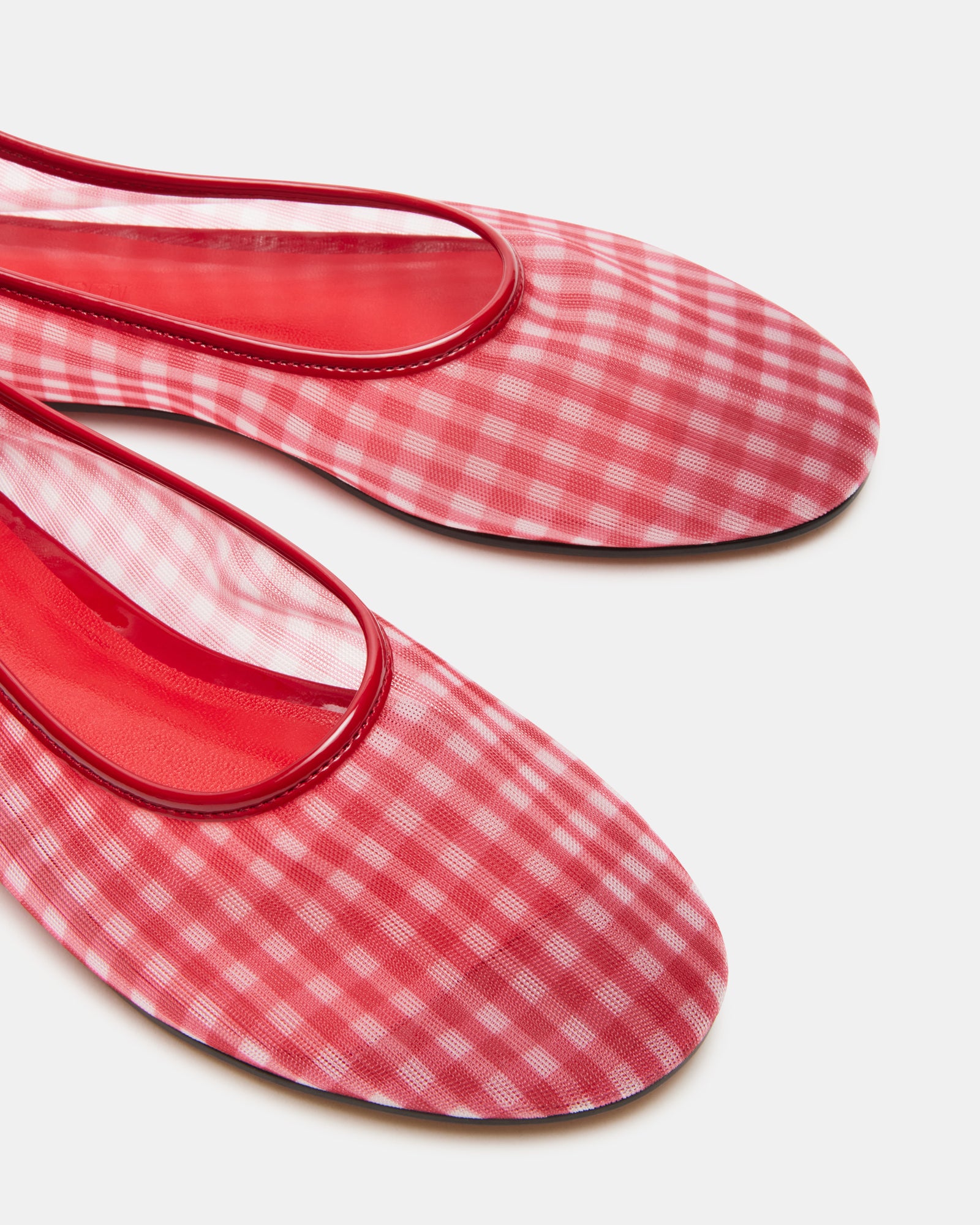 Side view of comfortable red ballet flats highlighting rounded toe.