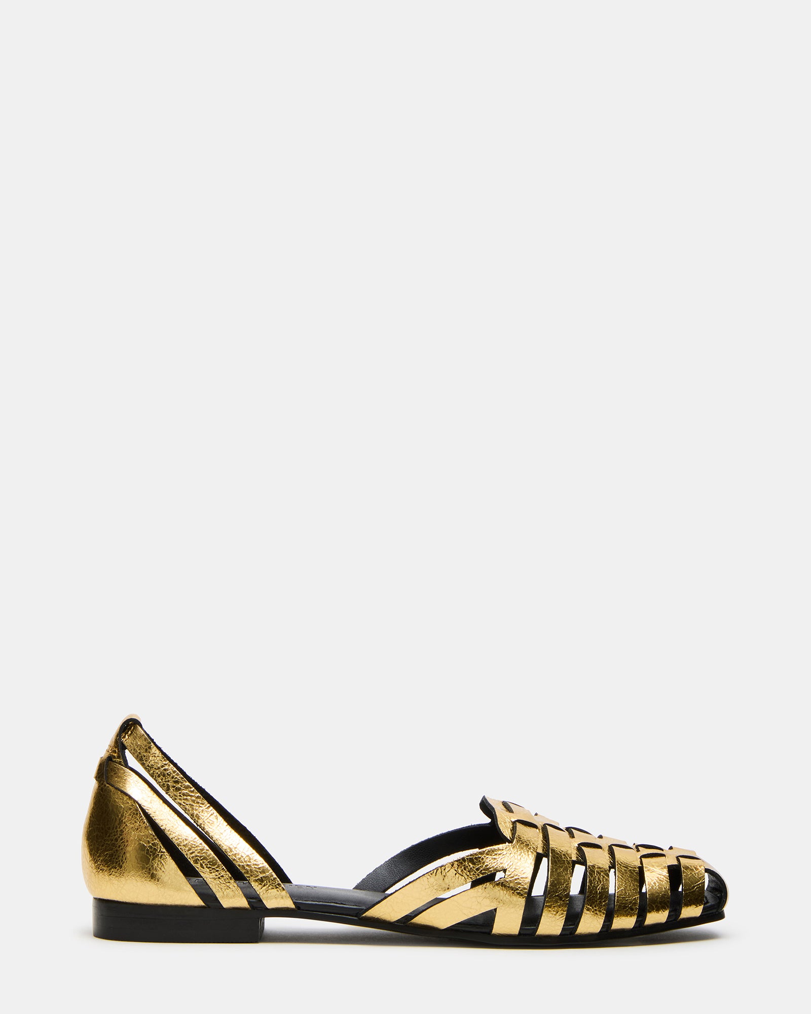 Front angle of brown leather flats styled with cropped trousers