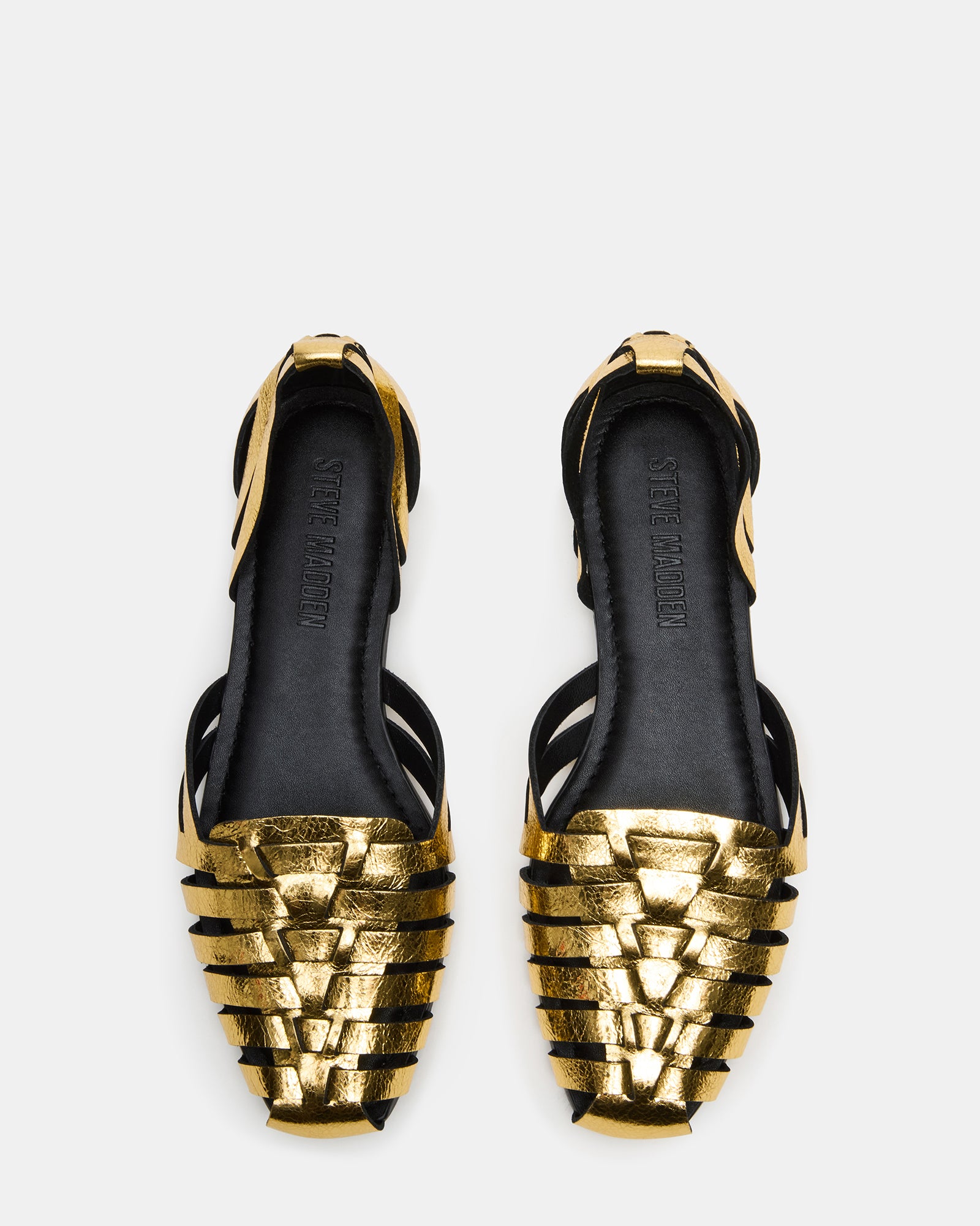 Front angle of brown leather flats styled with cropped trousers