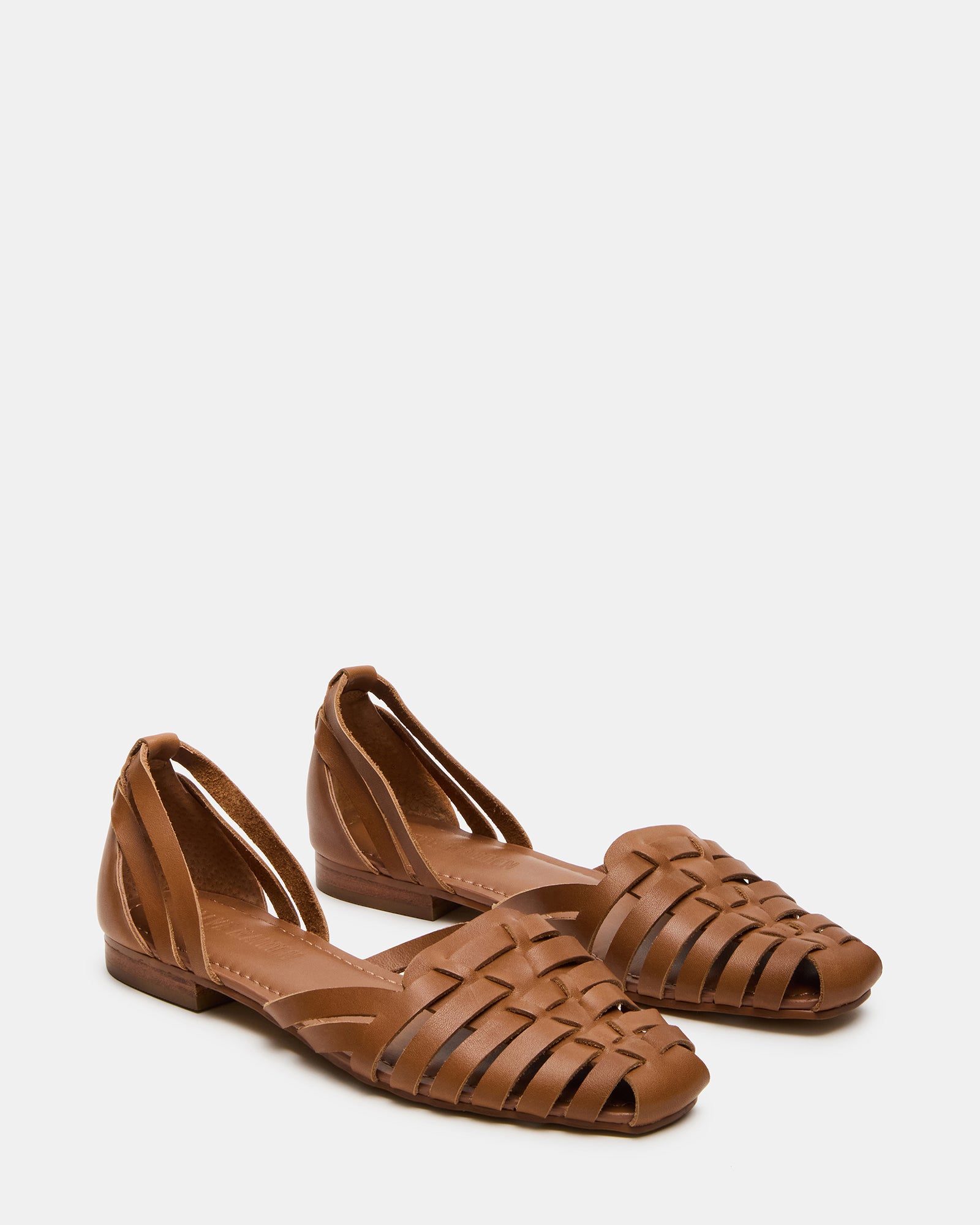 Side view of Medlin tan leather flats highlighting the fisherman-inspired design and synthetic sole