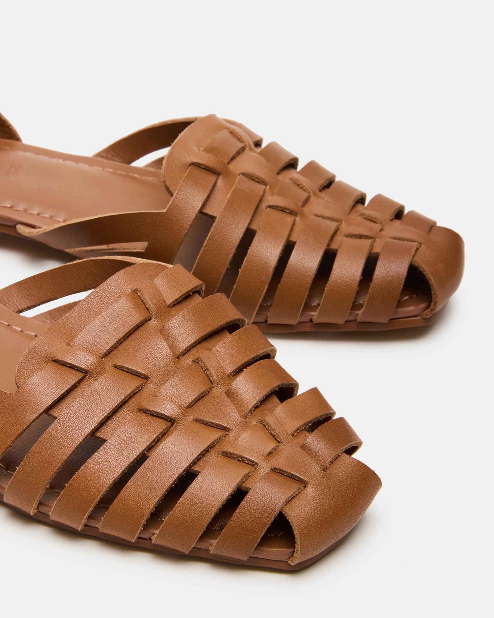 Close-up of the square toe detail on Medlin tan leather flats, showcasing craftsmanship and style