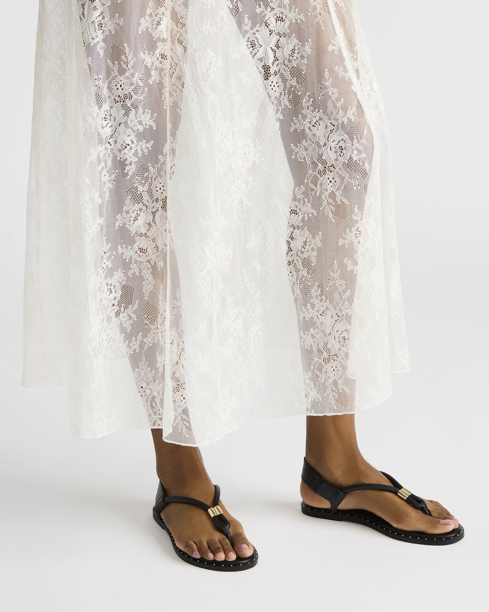 Fashionable black thong sandals with heels worn with summer outfit for 2025