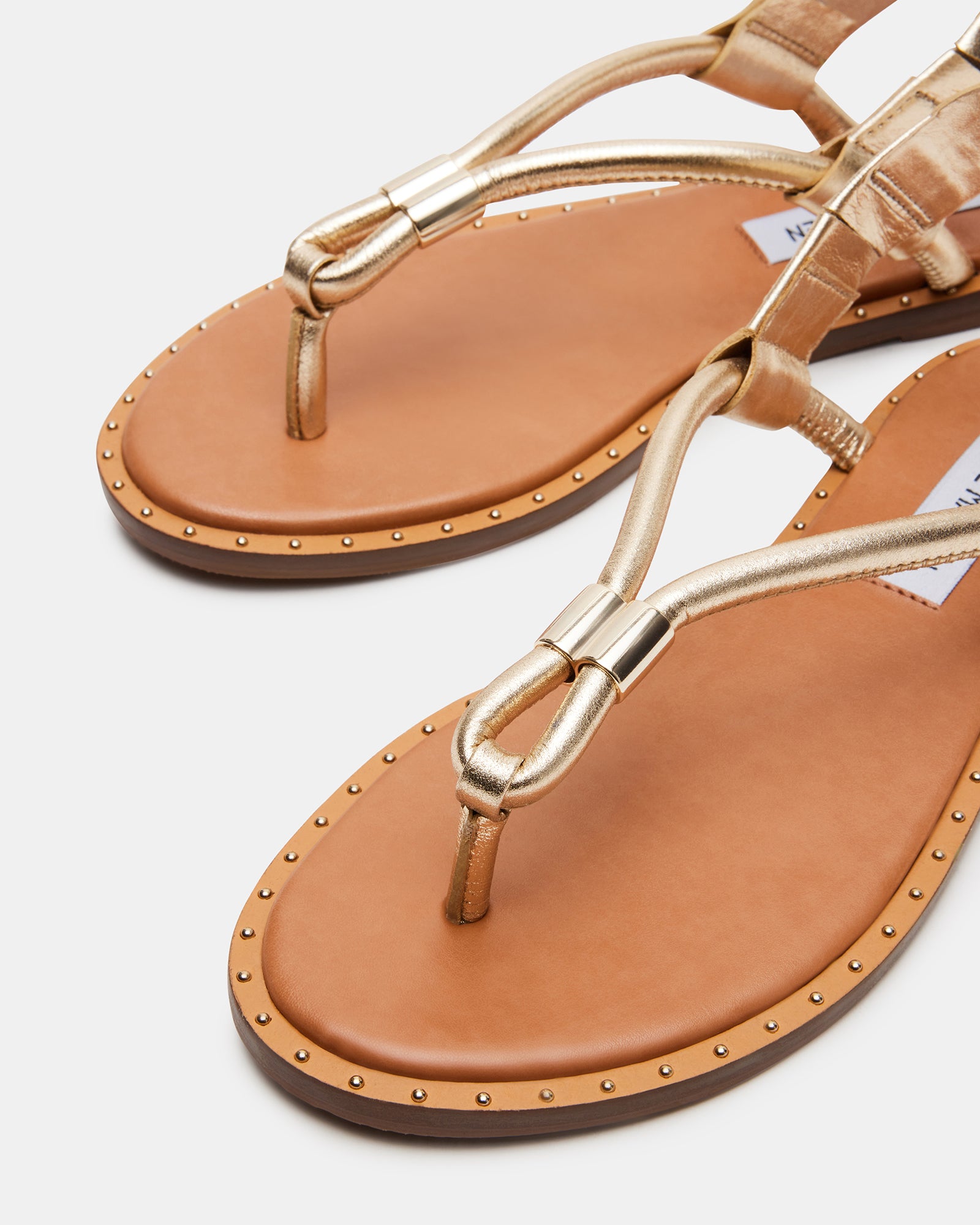 Close-up of the studded leather thong sandals showing texture and finish