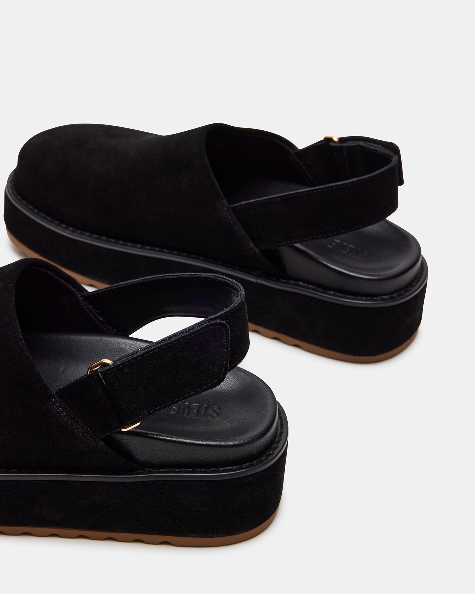 Lifestyle shot showing platform clogs in a modern café interior