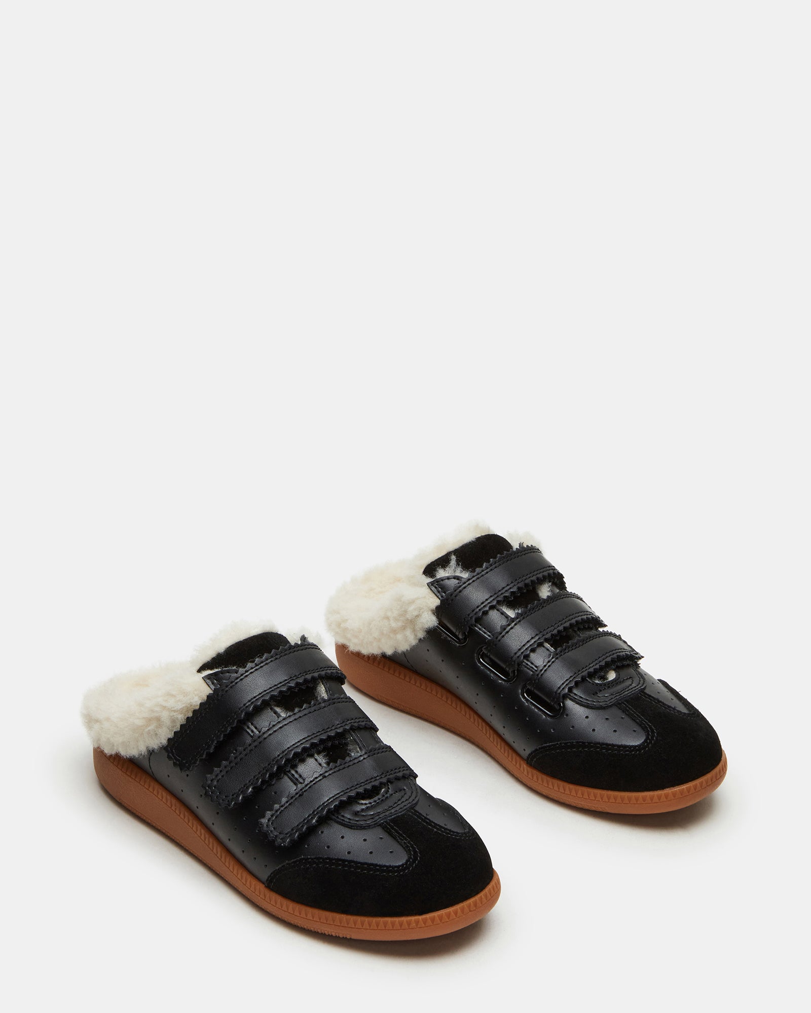 Side view of faux fur slip-on sneakers showcasing shearling lining.