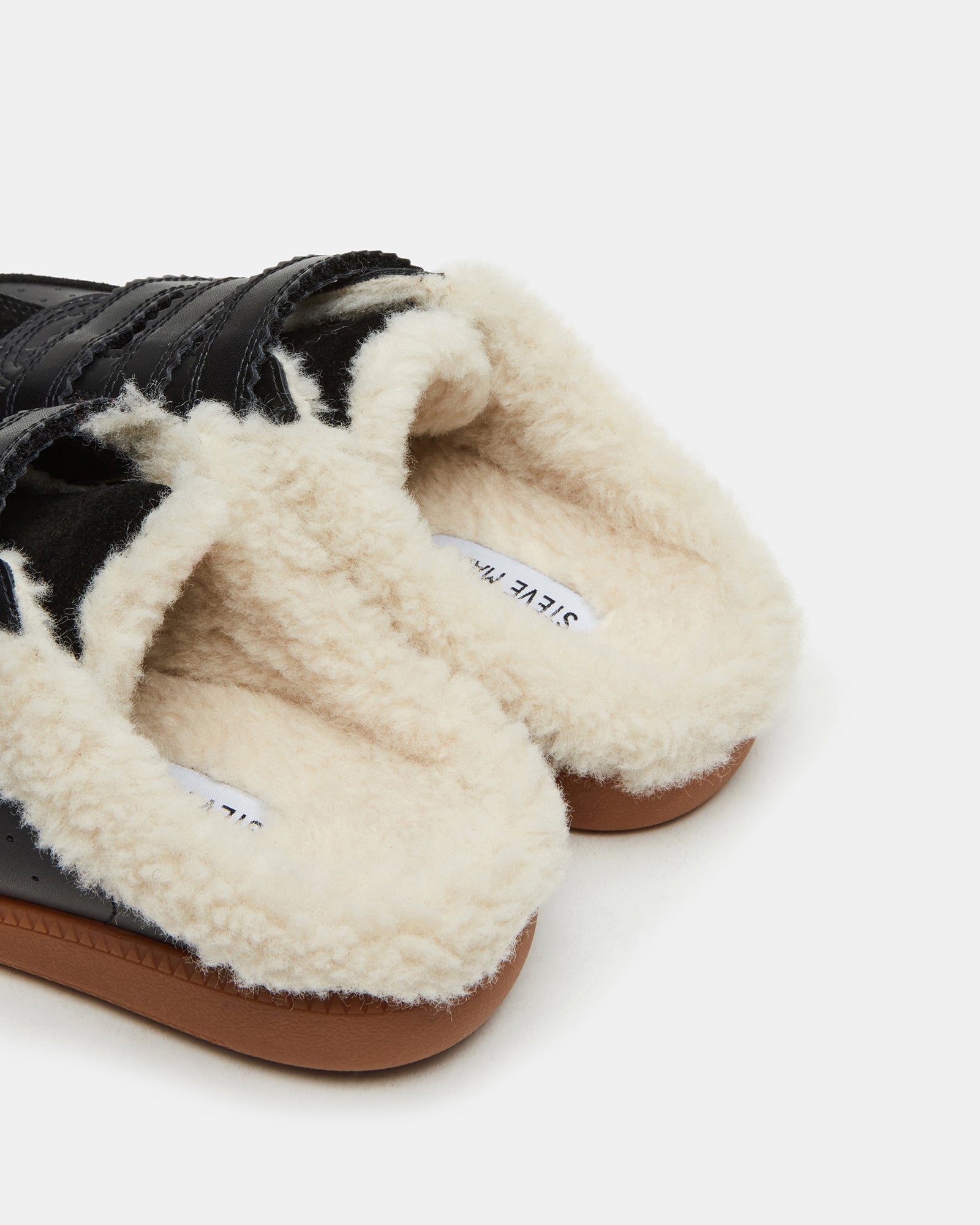 Close-up of Memento shearling lined tennis shoes with Velcro straps.