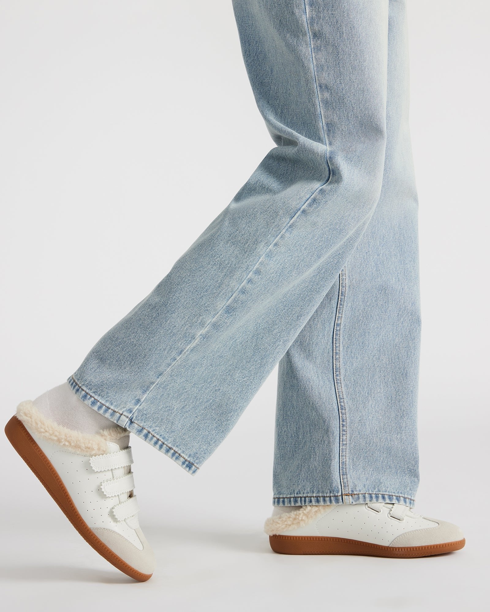 Side angle of faux fur sneakers with synthetic sole and comfortable fit, ideal for daily use