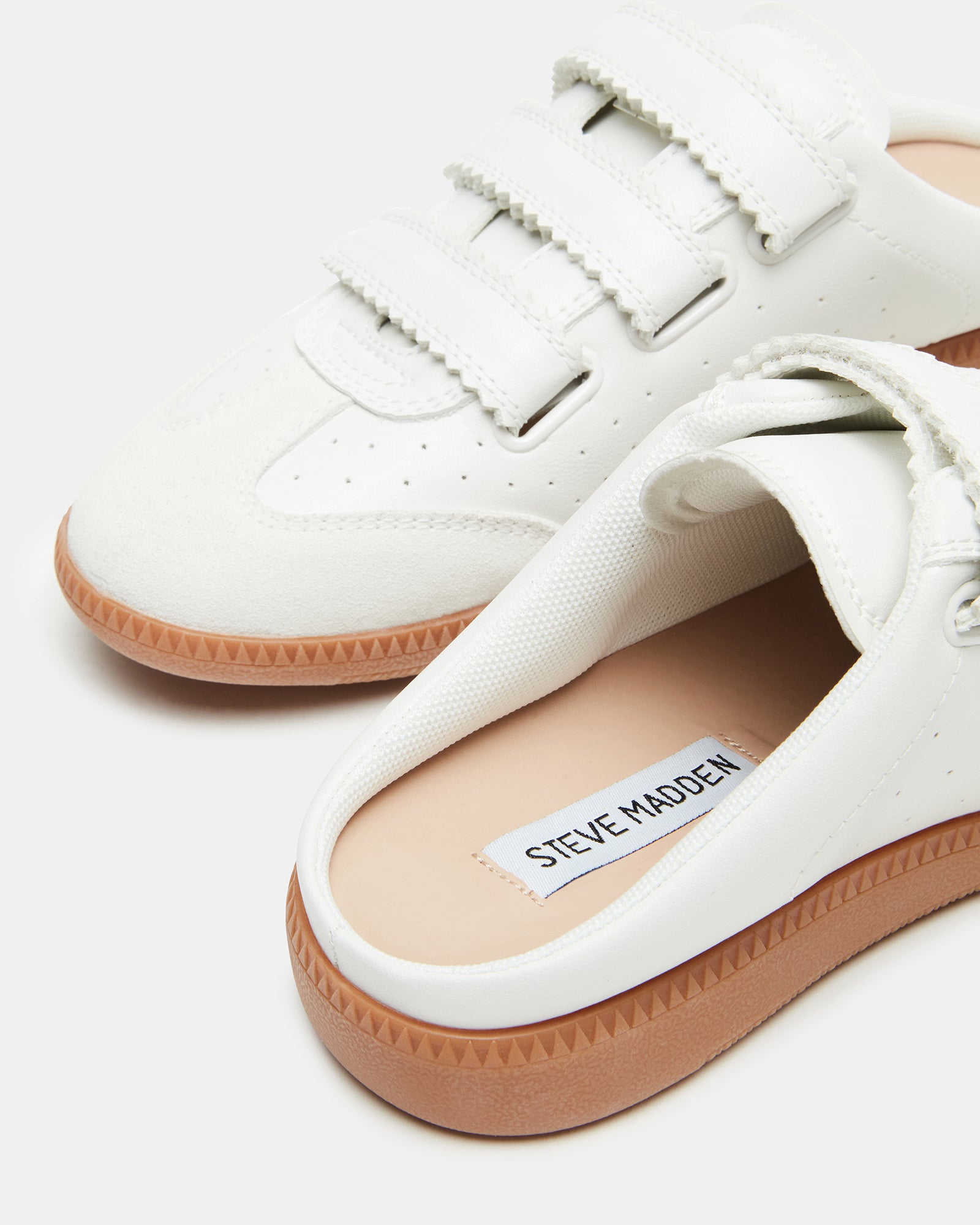 Memento white mule shoes styled with casual jeans