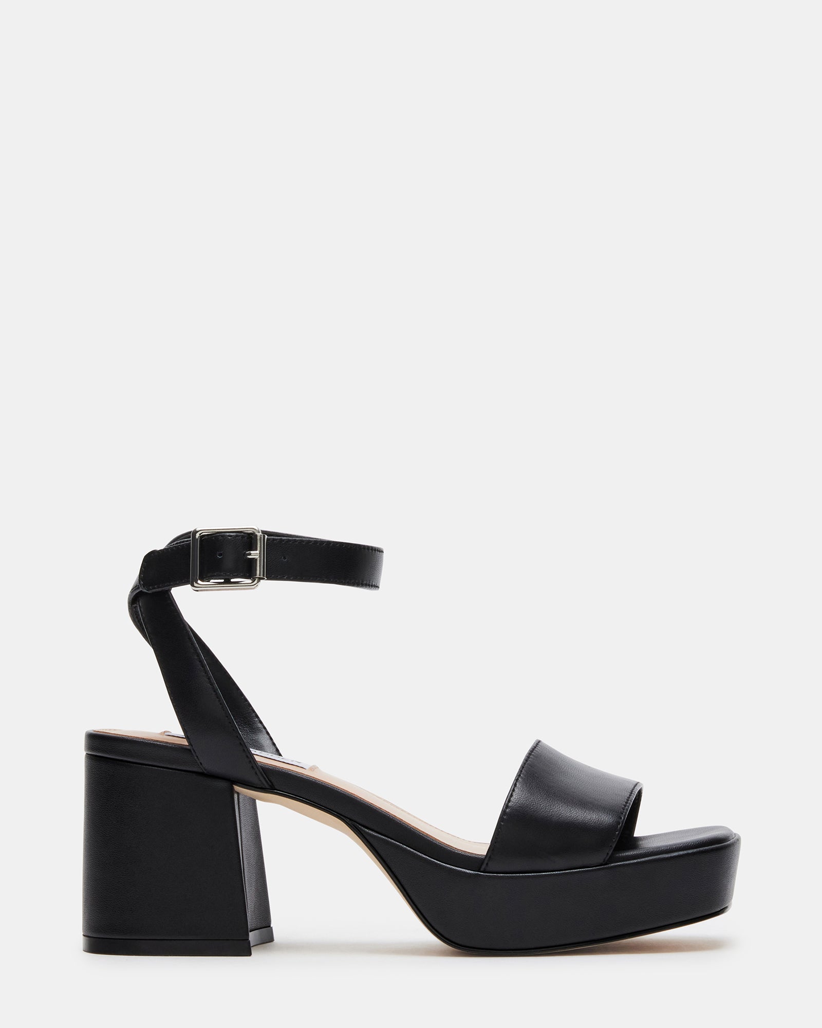 Front view of black leather platform heels with ankle strap on a model