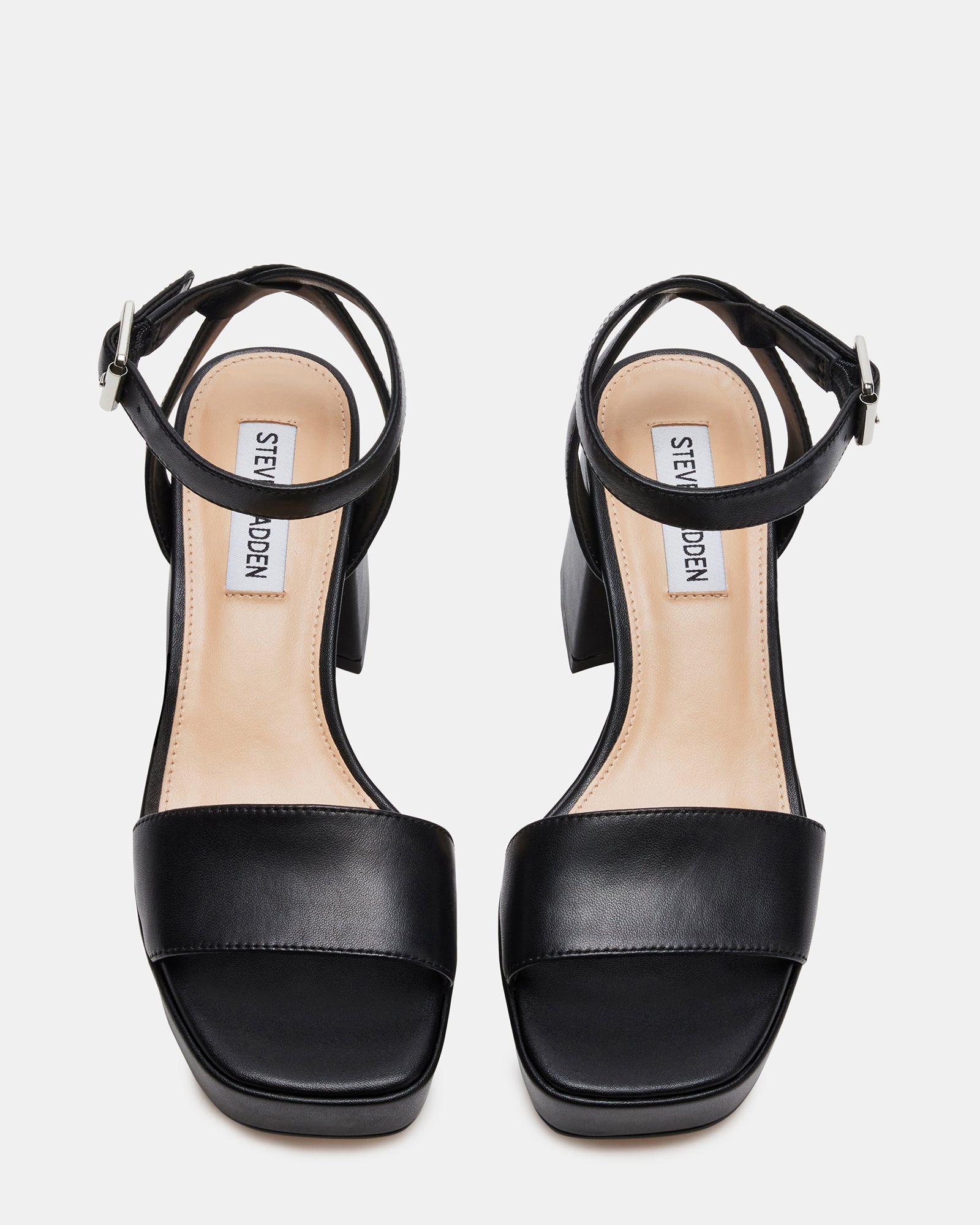 Side angle of MERCERR black leather heels highlighting the block heel and ankle strap