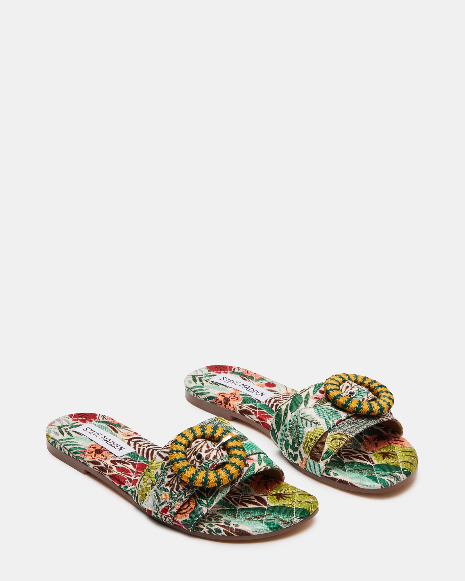 Comfort sandals with cushioned insole laid on a woven beach bag