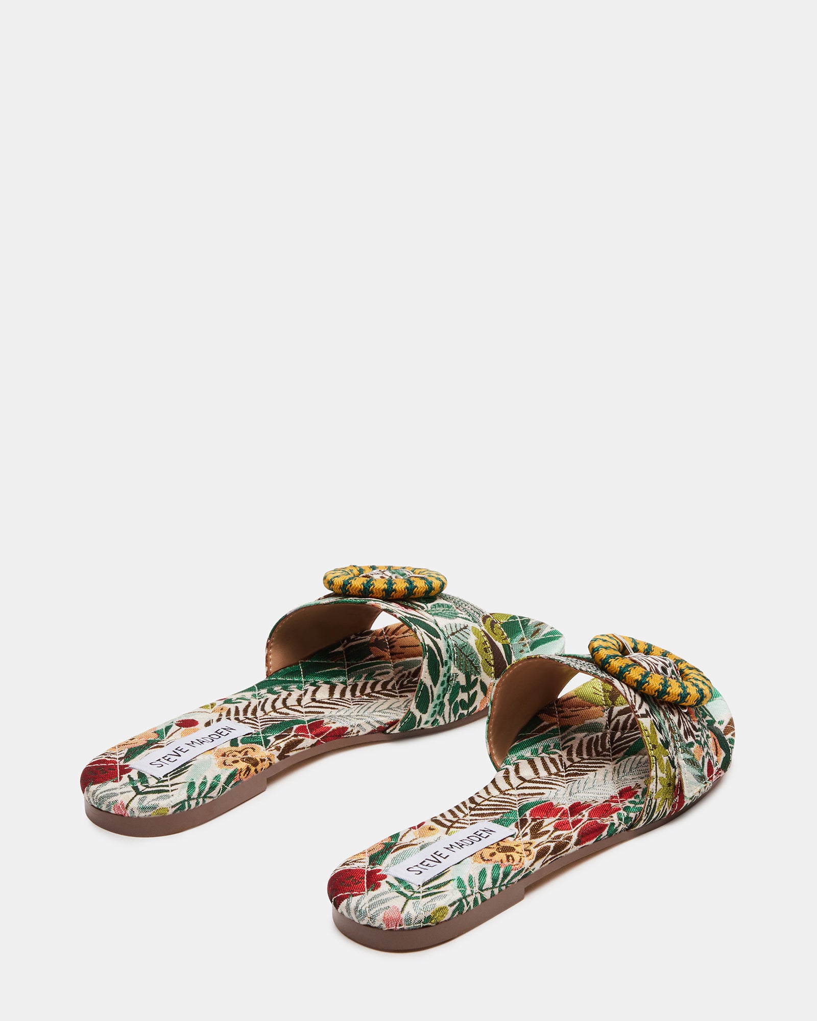 Comfort sandals with cushioned insole laid on a woven beach bag