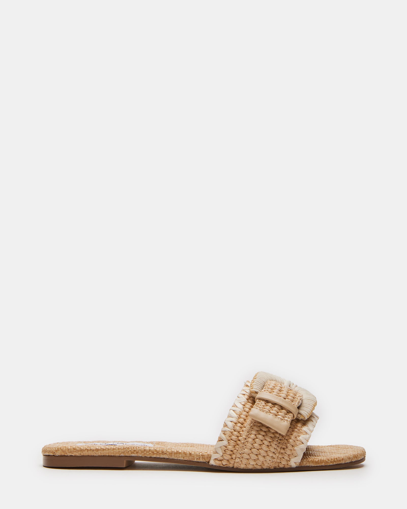 Merla raffia sandals displayed on wooden deck with coastal plants