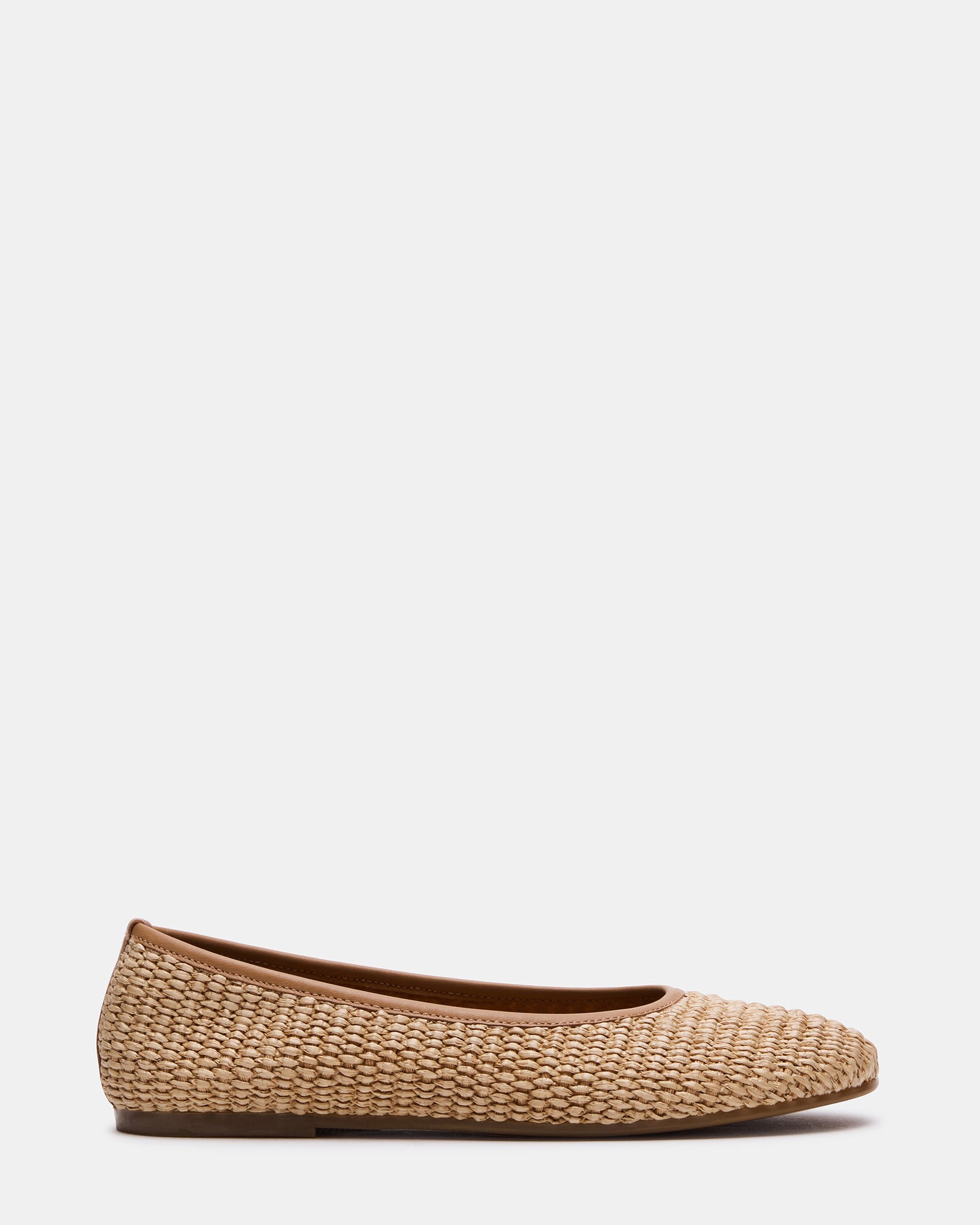 Side view of Merlot raffia ballet flats on a wooden floor.