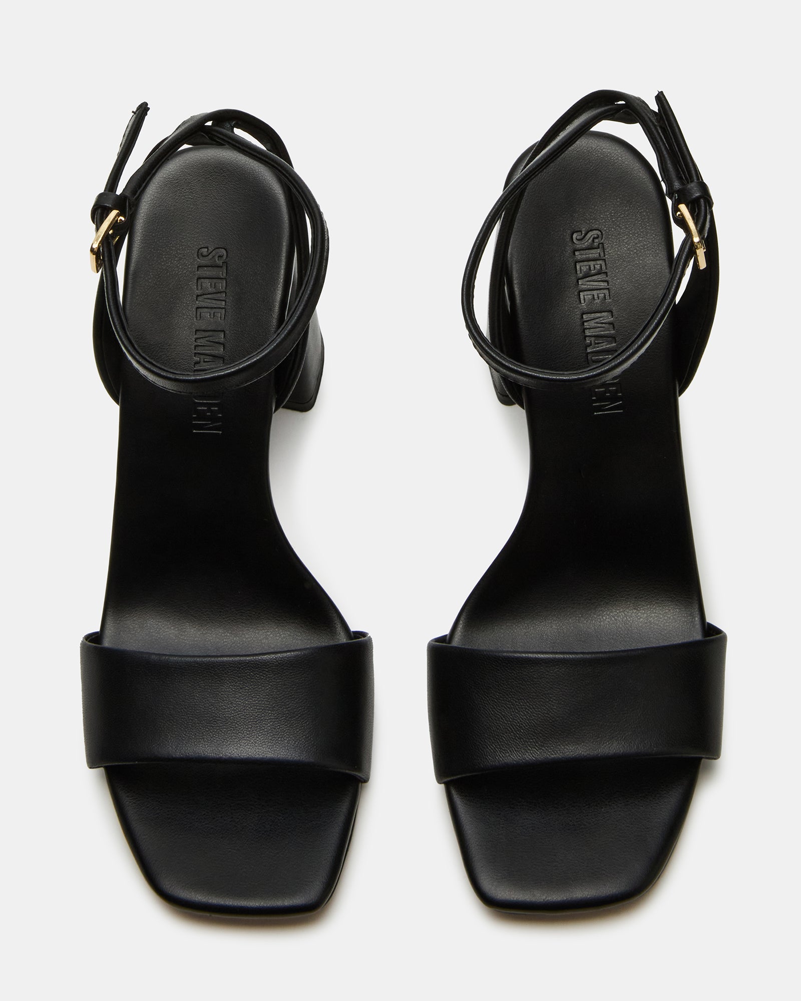 Close-up of the square toe and ankle strap design on these patent leather shoes
