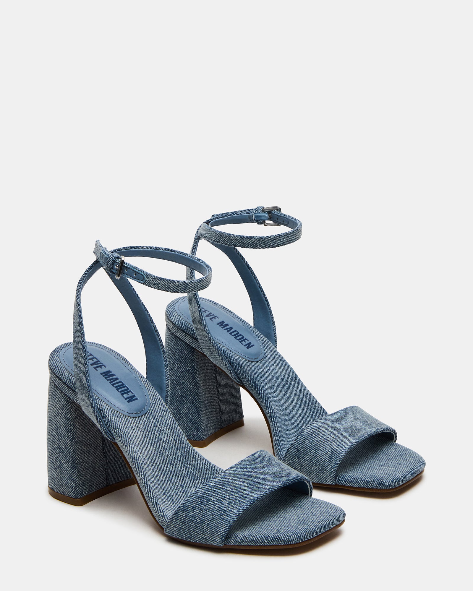 White block heels in a summer outfit with denim and a blouse