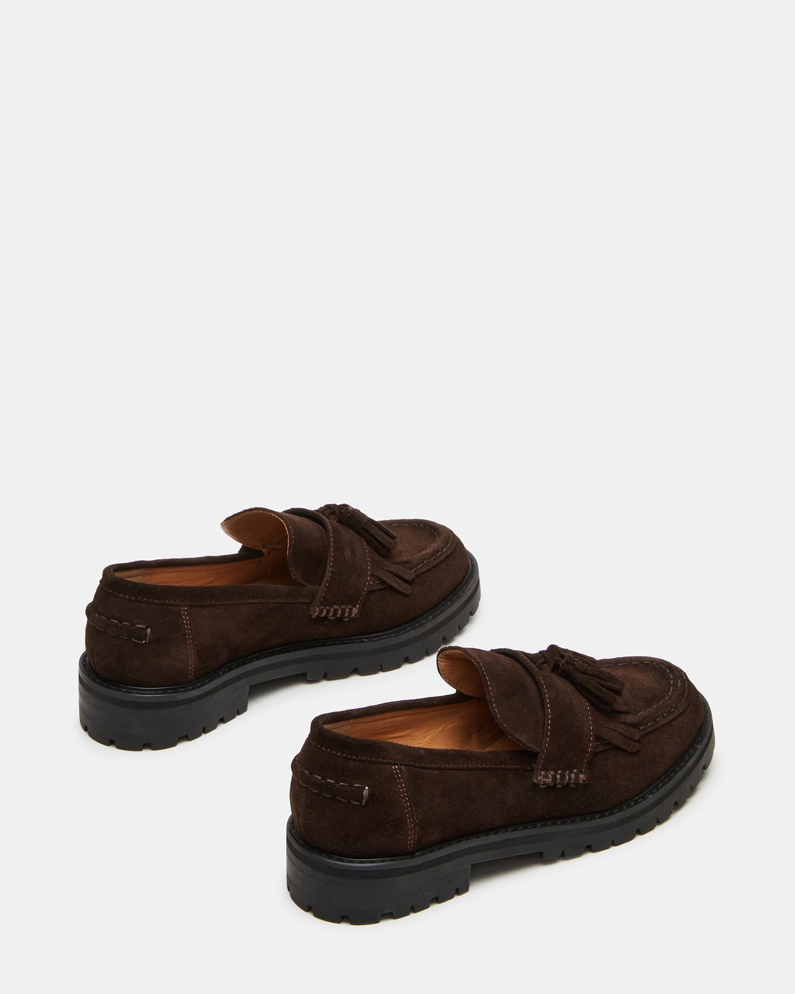 Close-up of suede shoes highlighting texture and stitching quality.