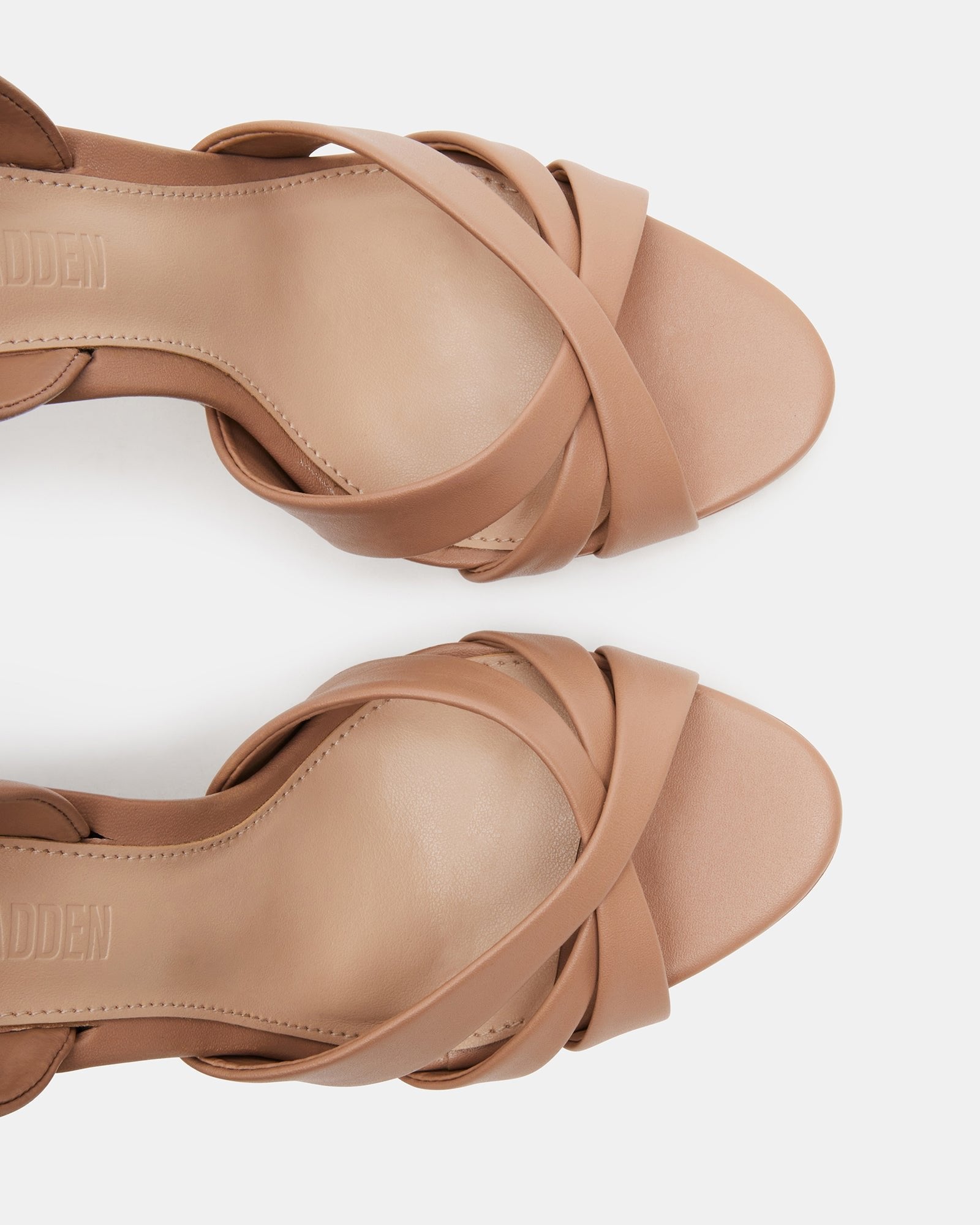 Nude slingback heels showcasing strappy design and stiletto heel.