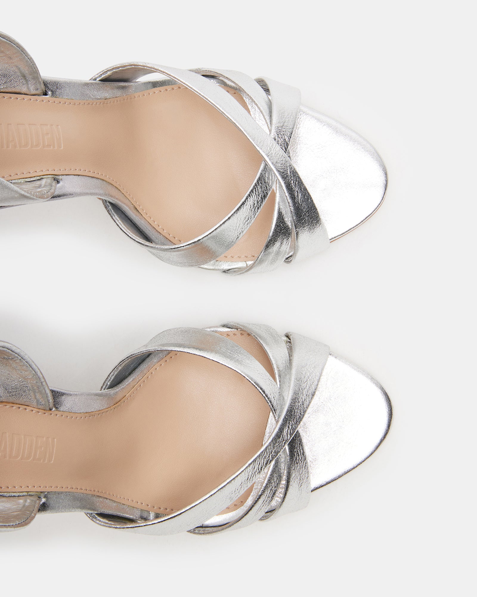 Close-up of MINX silver heels showing stiletto heel and slingback strap