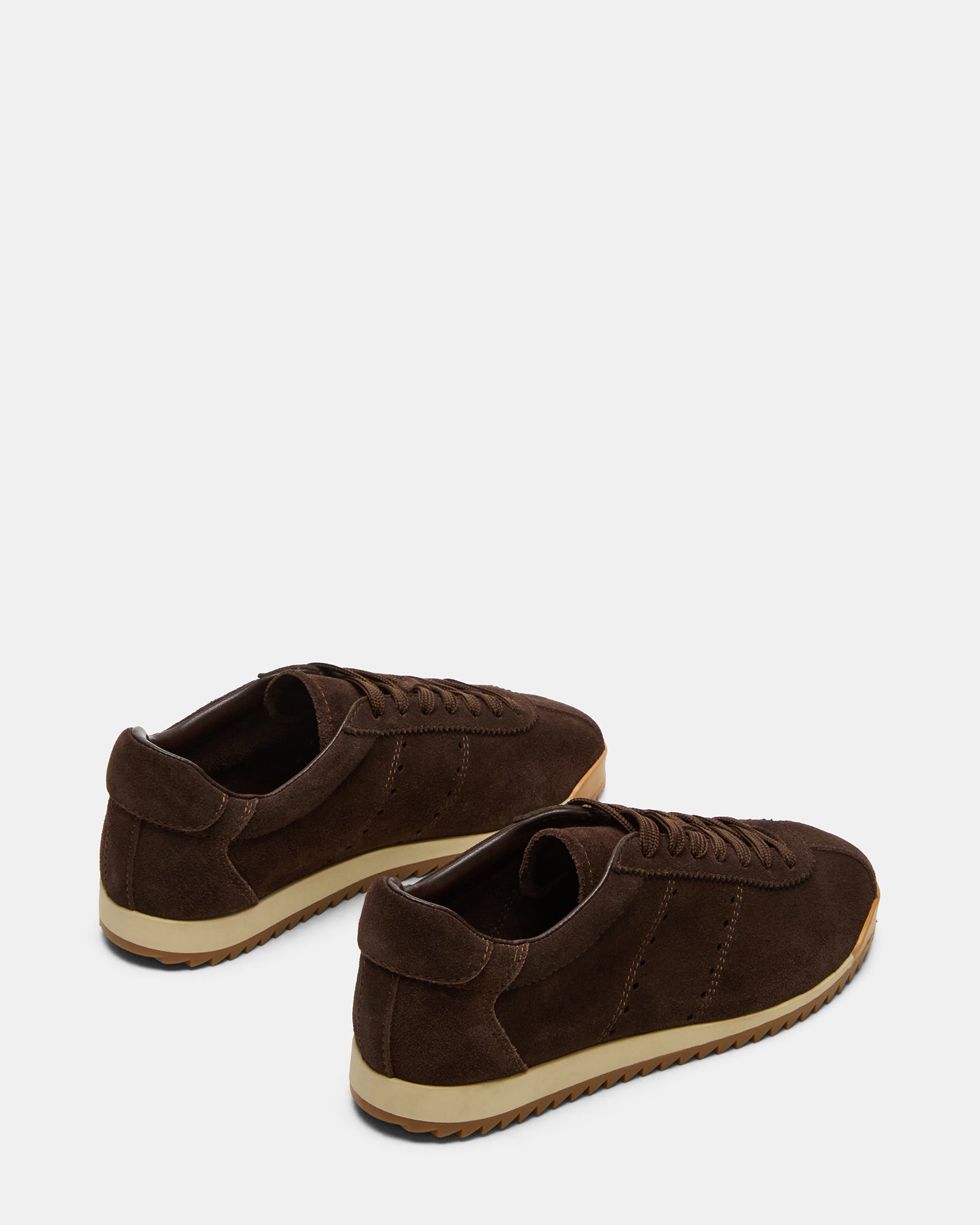 Chocolate brown athletic shoes paired with dark denim for a casual outfit