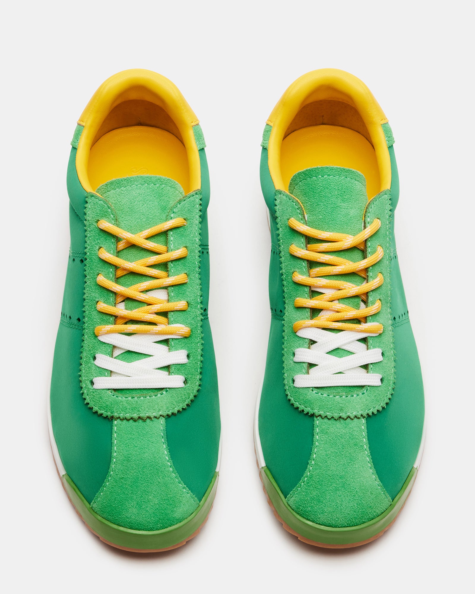 Side view of Mirage sneakers with striped laces and green accents
