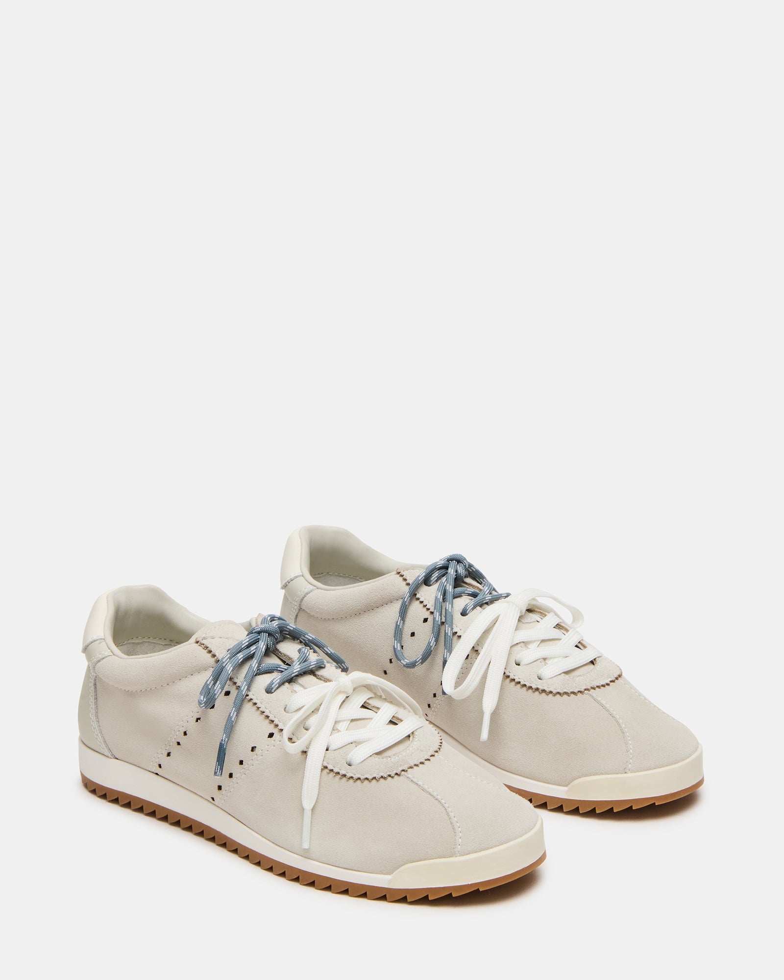 Side view of low-top Mirage sneakers styled with jeans for daily wear